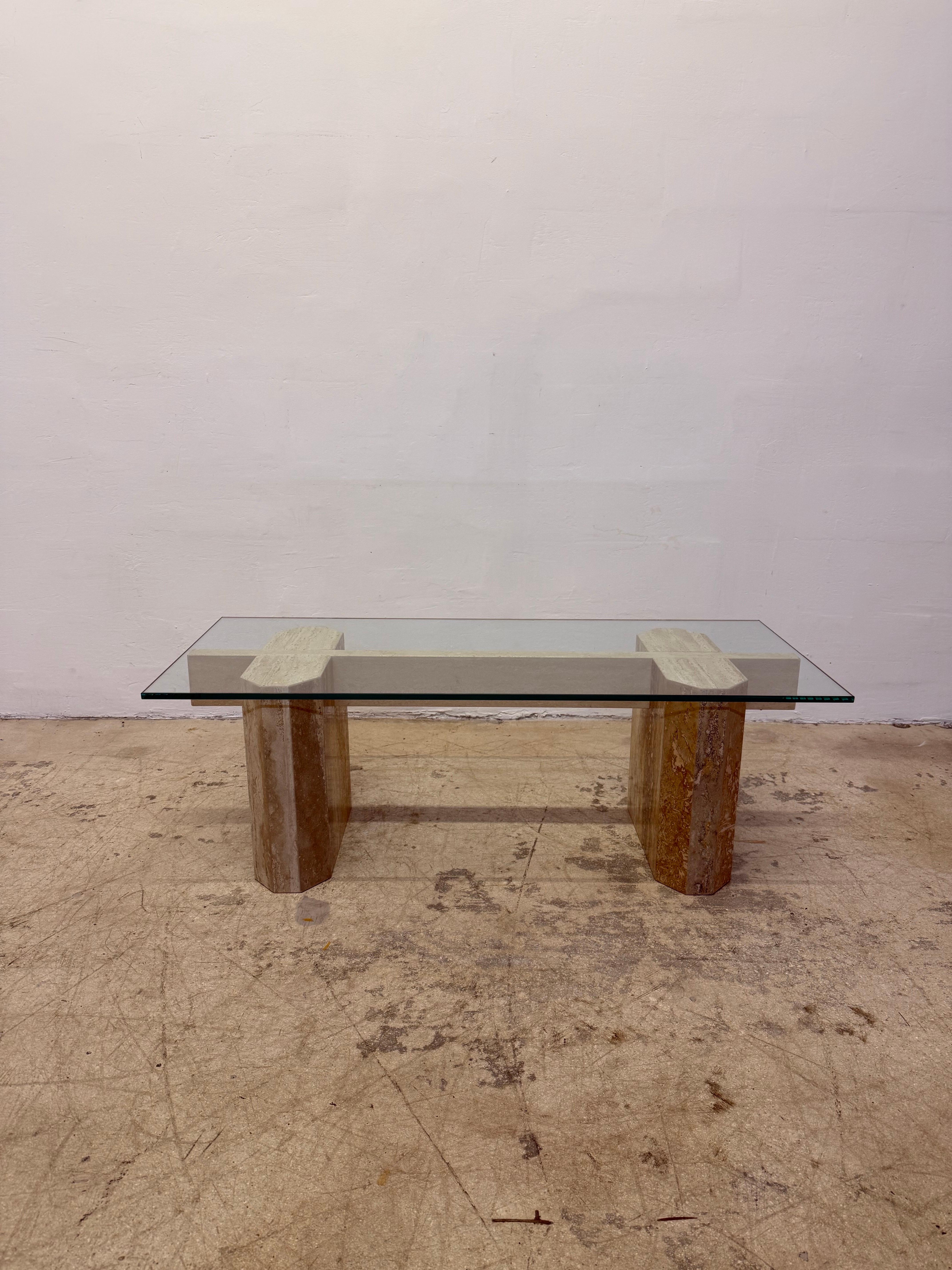 Travertine base coffee or cocktail table with long center travertine support and 1/2” polished edge glass top from the 1970s.
