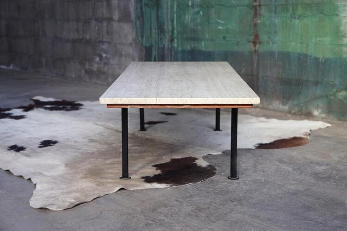 Very cool unique travertine table with Knoll legs, made by an architect in the 70s or 80s. It was acquired from the home of this architect in Madison, WI. Along with it from the same collection there was a round travertine table top with a knoll