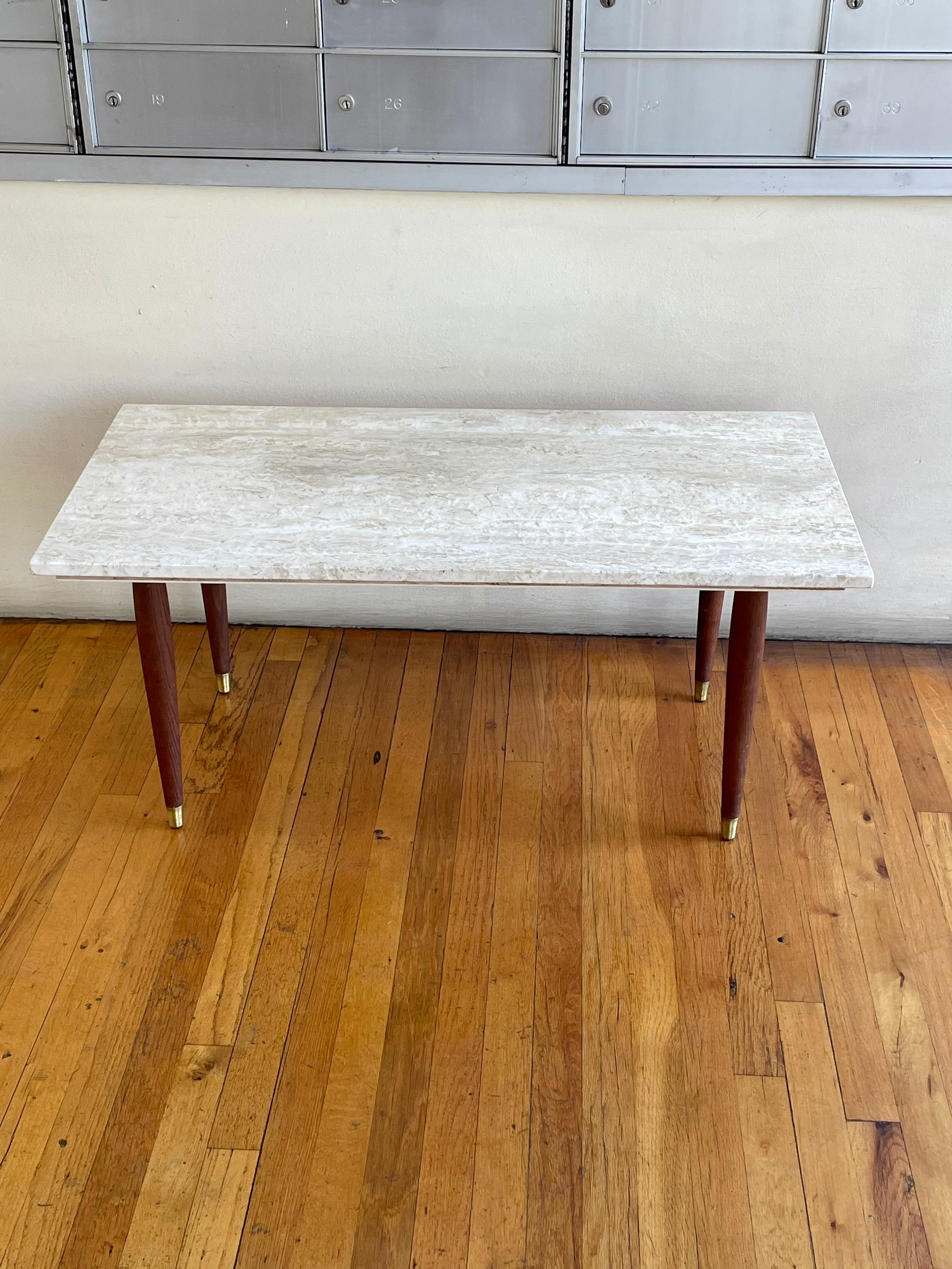 Simple 1950's solid travertine top coffee table, sitting on solid walnut tapered legs with polished brass caps solid and sturdy, simple and elegant design great look.