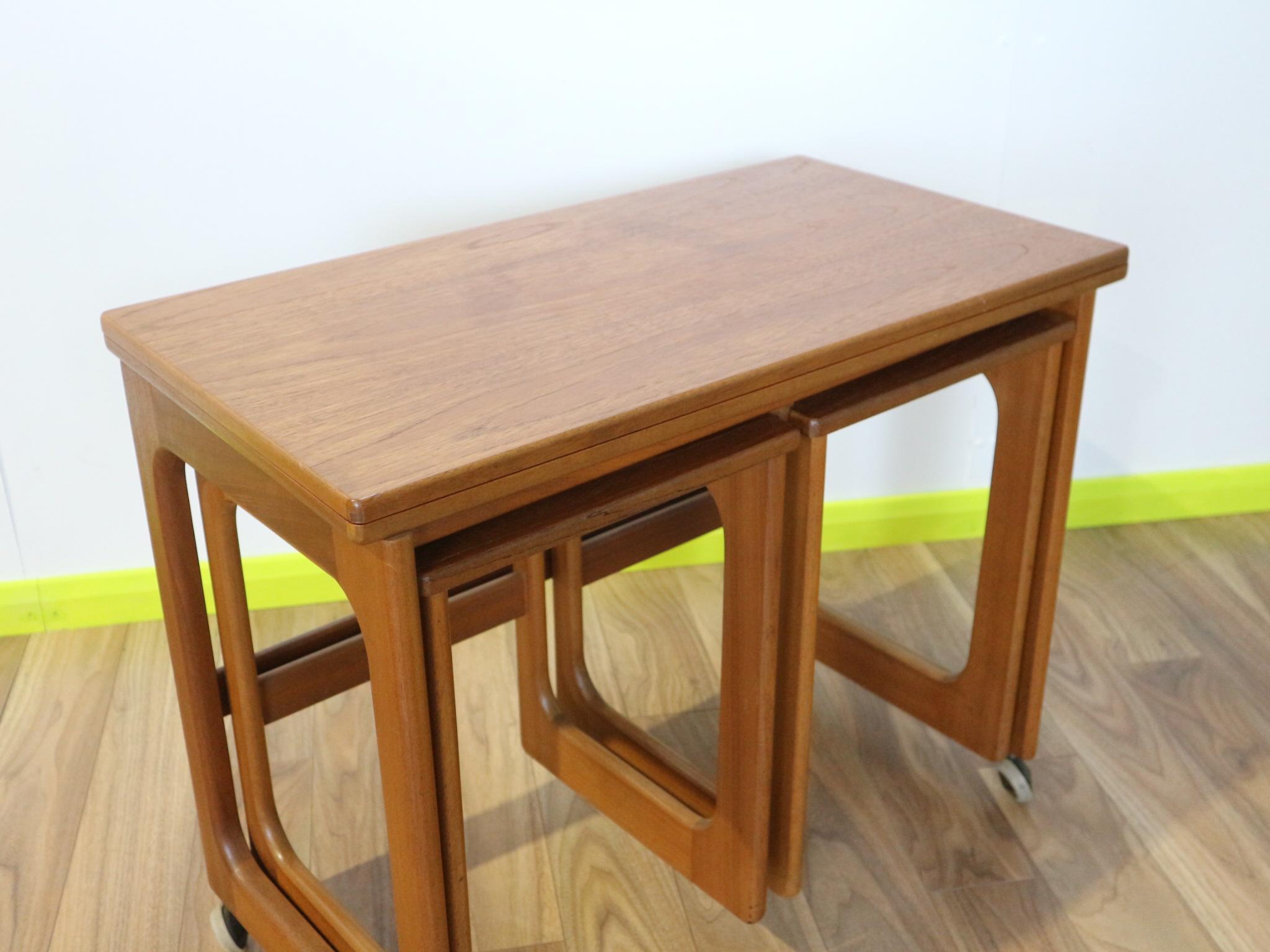 This striking nest of three tables by Scottish brand AH Mcintosh in teak is part of the Triform range. With distinctive mid century design, and a modular, extending table it can be used for a variety of occasions. This flexible unit tucks in neatly