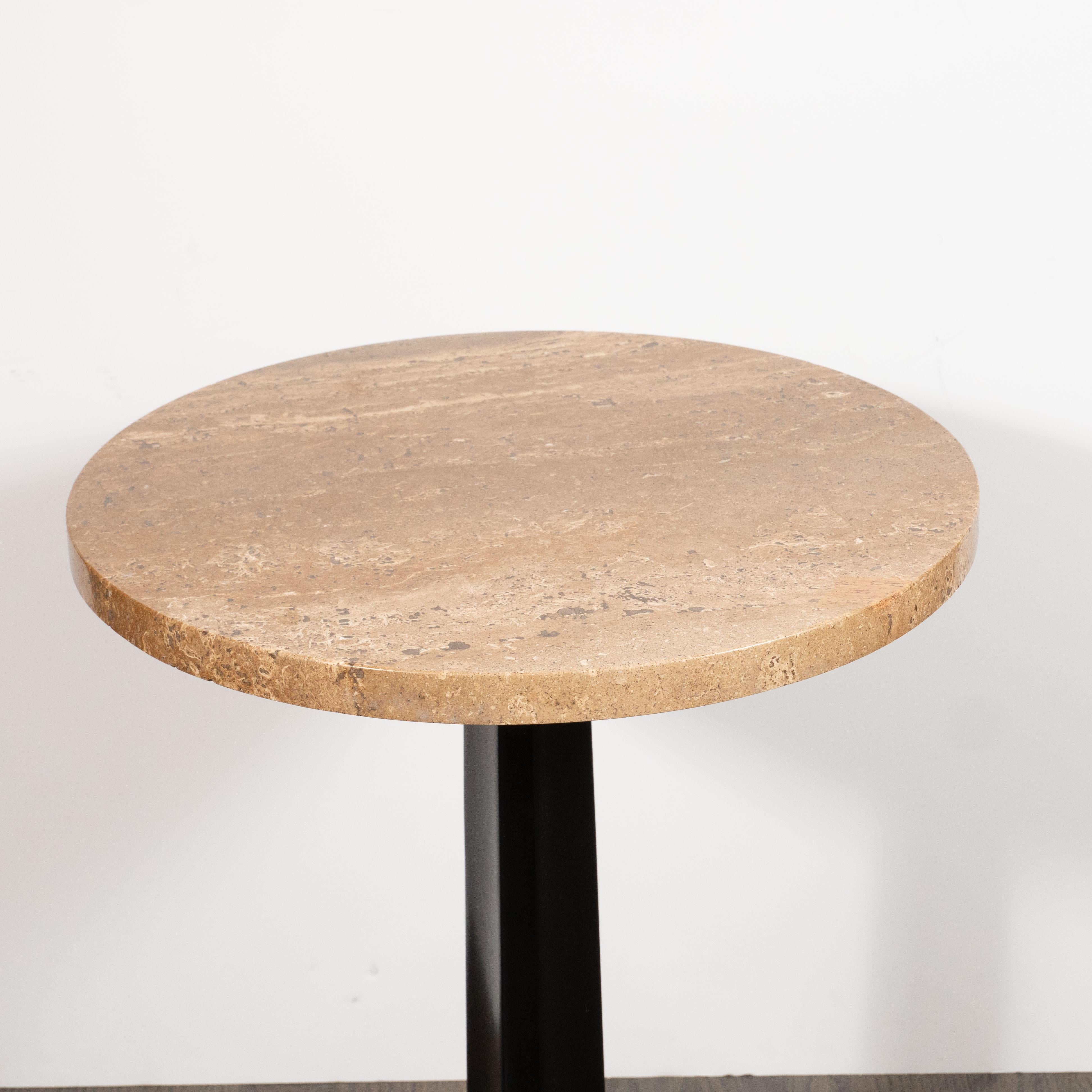This sophisticated Mid-Century Modern tripod side table was designed by Edward Wormley for Dunbar, circa 1950. It features three stylized scroll form feet that attach to a hexagonal base which supports a circular top made of exotic travertine. With