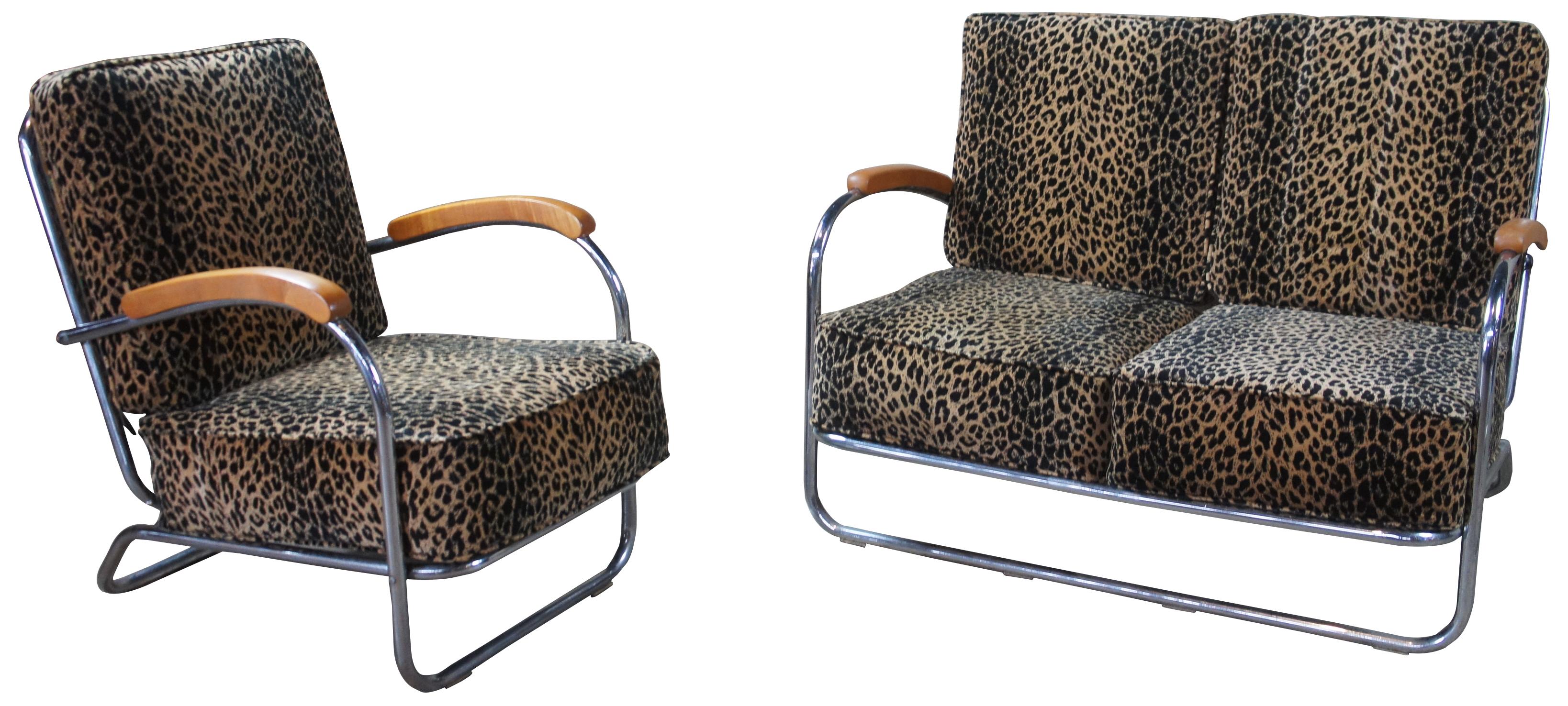 Mid-Century Modern tubular chrome and leopard upholstered chair and love seat. Features wood arms and tubular serpentine chrome frame. Very similar to the Art Deco style that Wolfgang Hoffmann designed for Howell Furniture.

Sofa - 44.5