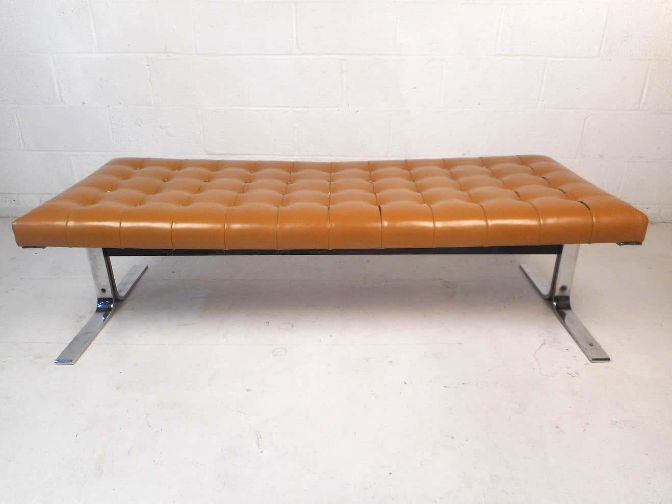 This unique vintage bench features a tufted vinyl upholstery covering the seating surface ensuring comfort. A sturdy chrome cantilevered base provides stability and style. A distinctive addition to any home, business, or office. Please confirm item