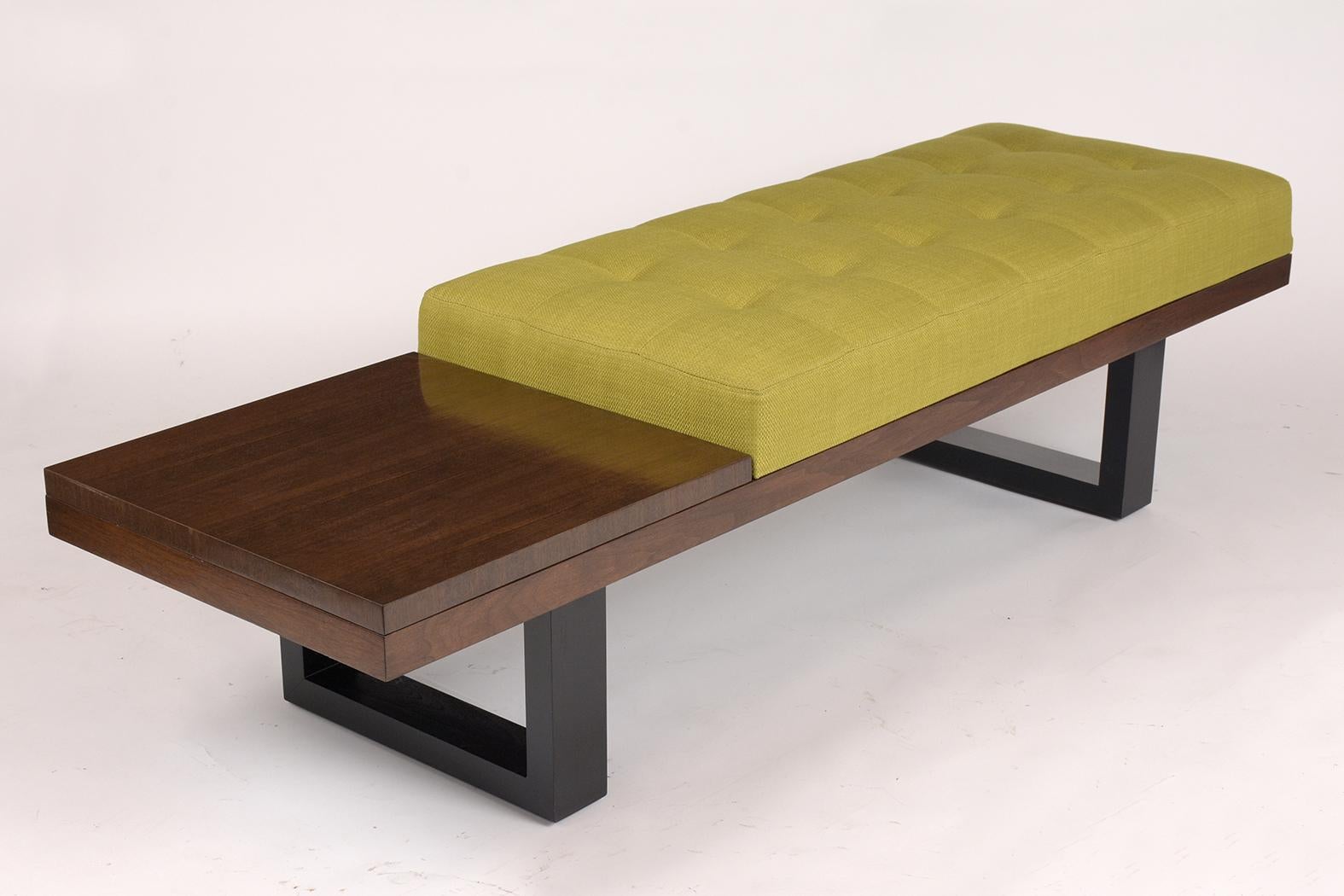 This Mid-Century Modern style bench is been newly refinish in a two tones dark walnut and black color with a lacquered finish. This stylish bench comes with a very comfortable single tufted seat newly upholstered with a chartreuse color fabric this