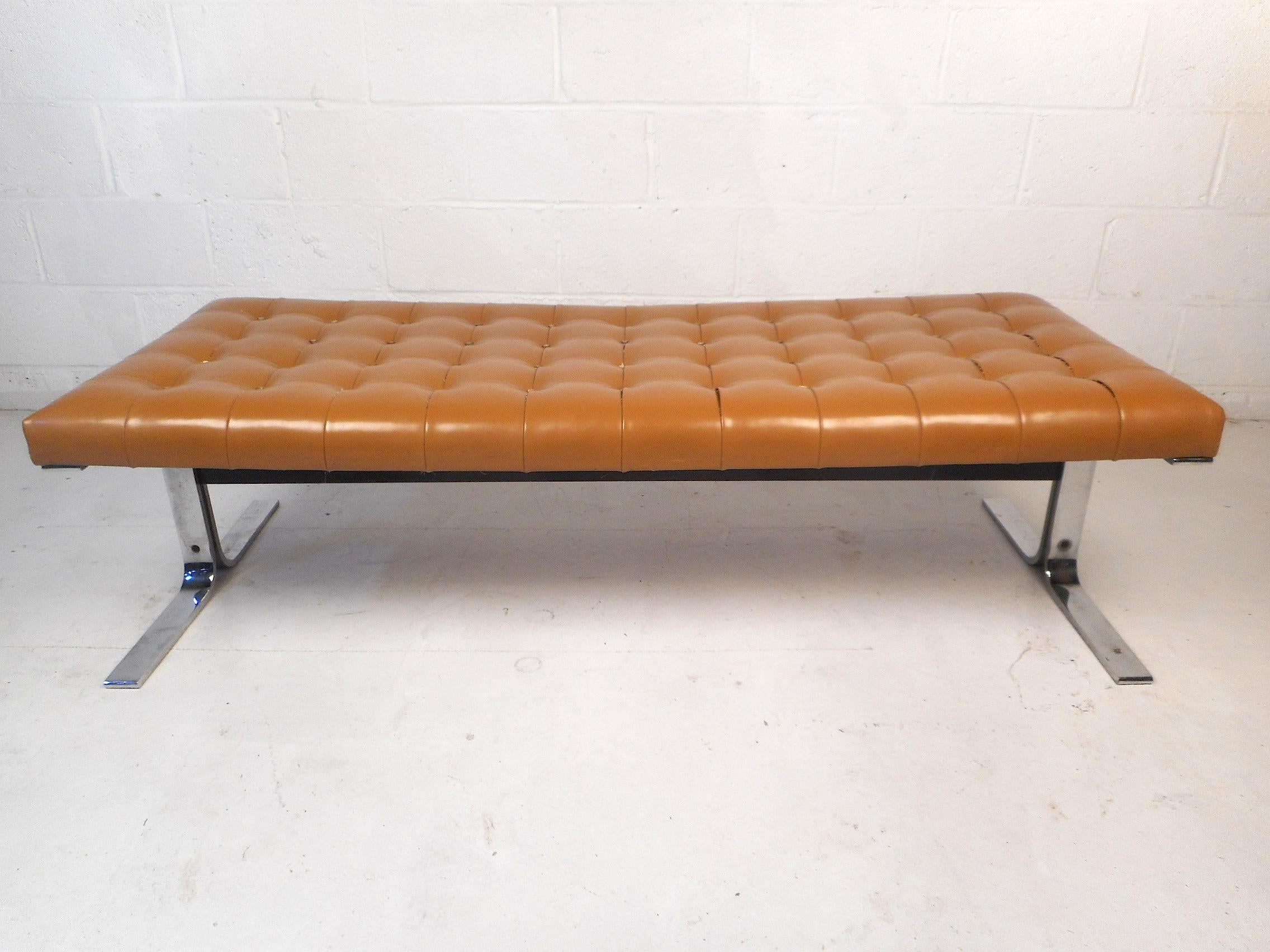 This unique vintage bench features a tufted vinyl upholstery covering the seating surface ensuring comfort. A sturdy chrome cantilevered base provides stability and style. A distinctive addition to any home, business, or office. Please confirm item