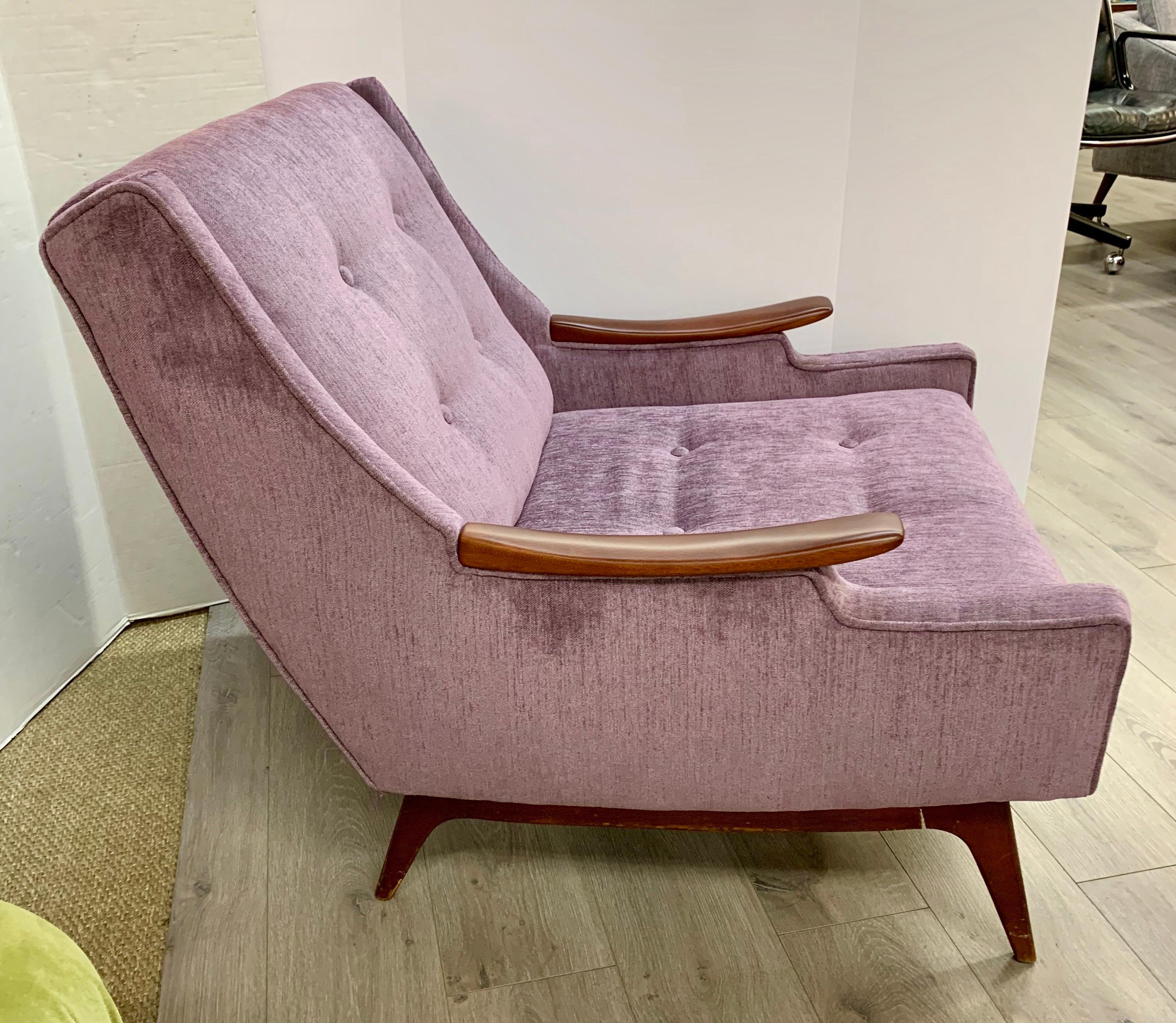 Elegant Mid-Century Modern period lounge chair done in newer lavender fabric that features tufting at backrest and seat. Iconic in every way!