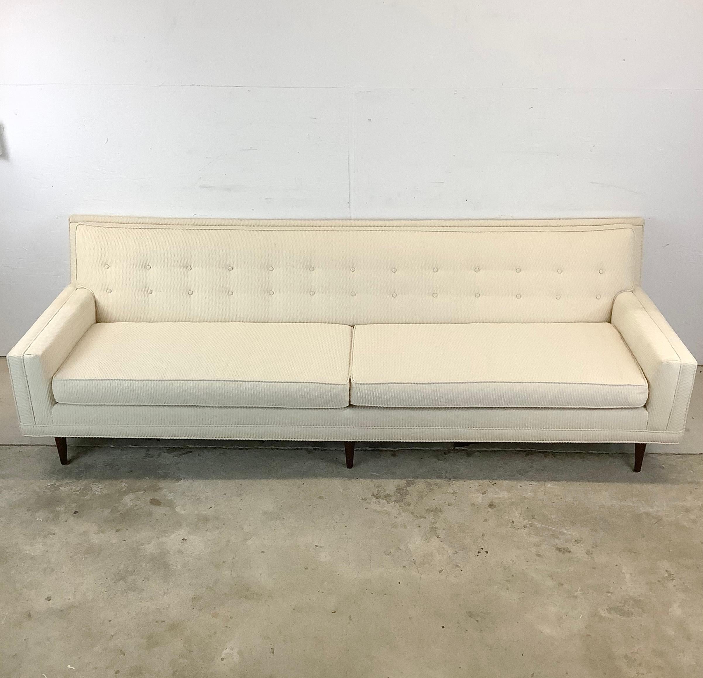 This 8ft Mid-Century Modern Sofa makes a luxurious centerpiece that captures the essence of timeless design. Crafted with exquisite attention to detail, this vintage Edward Wormley style sofa exudes the iconic elegance of mid-century modernism,