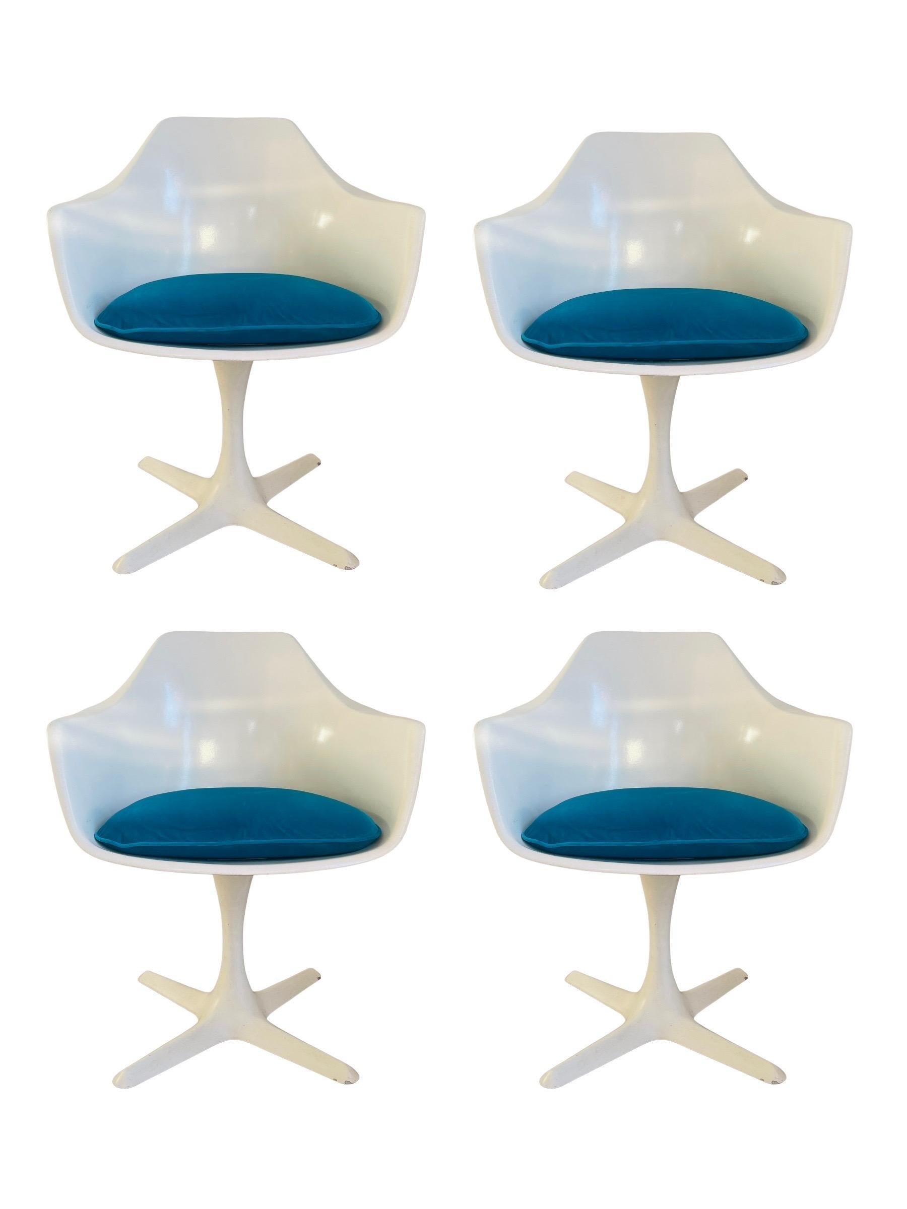 Mid-Century Modern tulip table and shell chair set in great condition. This set includes (1) Saarinen style tulip table and (4) propeller base shell armchairs by Burke. Chairs are molded fiberglass with new Turquoise Velvet upholstered seat cushions