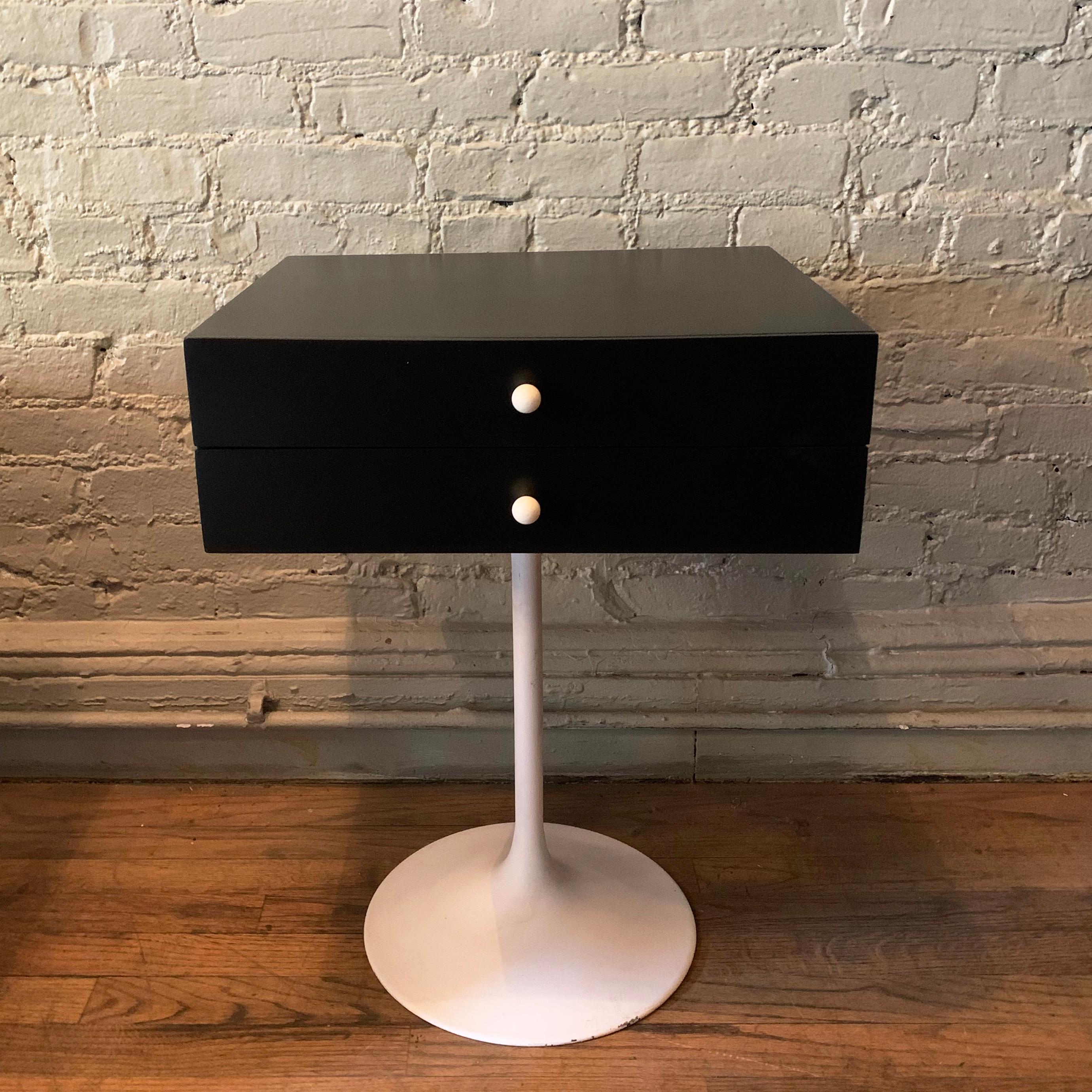 Mid-Century Modern, side table or nightstand features a white tulip base with contrasting black, two drawer top with white porcelain pulls. Cabinet height is 6 inches.