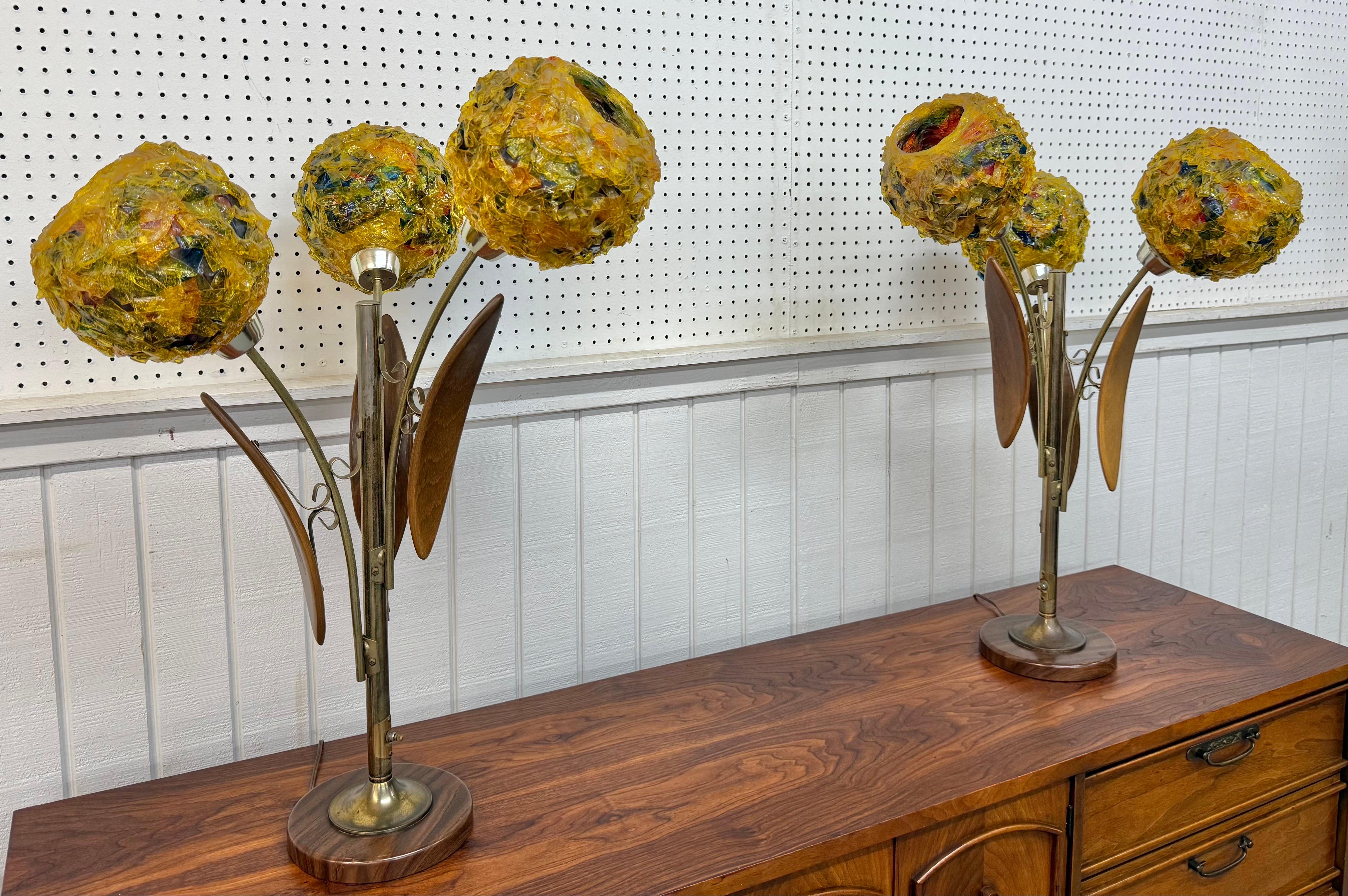 This listing is for a pair of unique Mid-Century Modern Tulip Spaghetti Shade Table Lamps. Featuring a floral design, three multi-colored spaghetti shade lights, brass body, walnut sculpted leaves, round base, and original cord. This is an