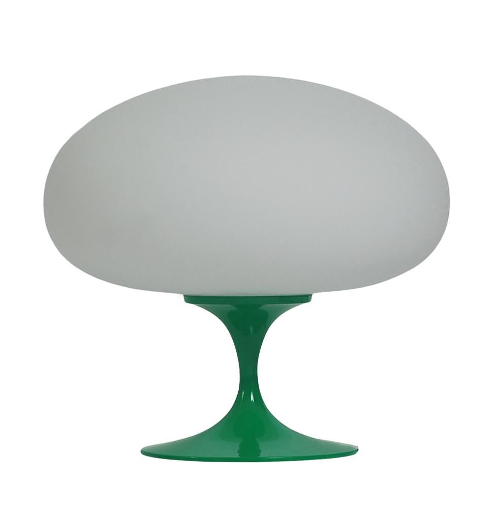 A gorgeous tulip form table lamp after Laurel Lamp company. It features a cast aluminum base in green powder coat with mouth blown frosted white glass shades. It takes one standard bulb up to 100 watts.