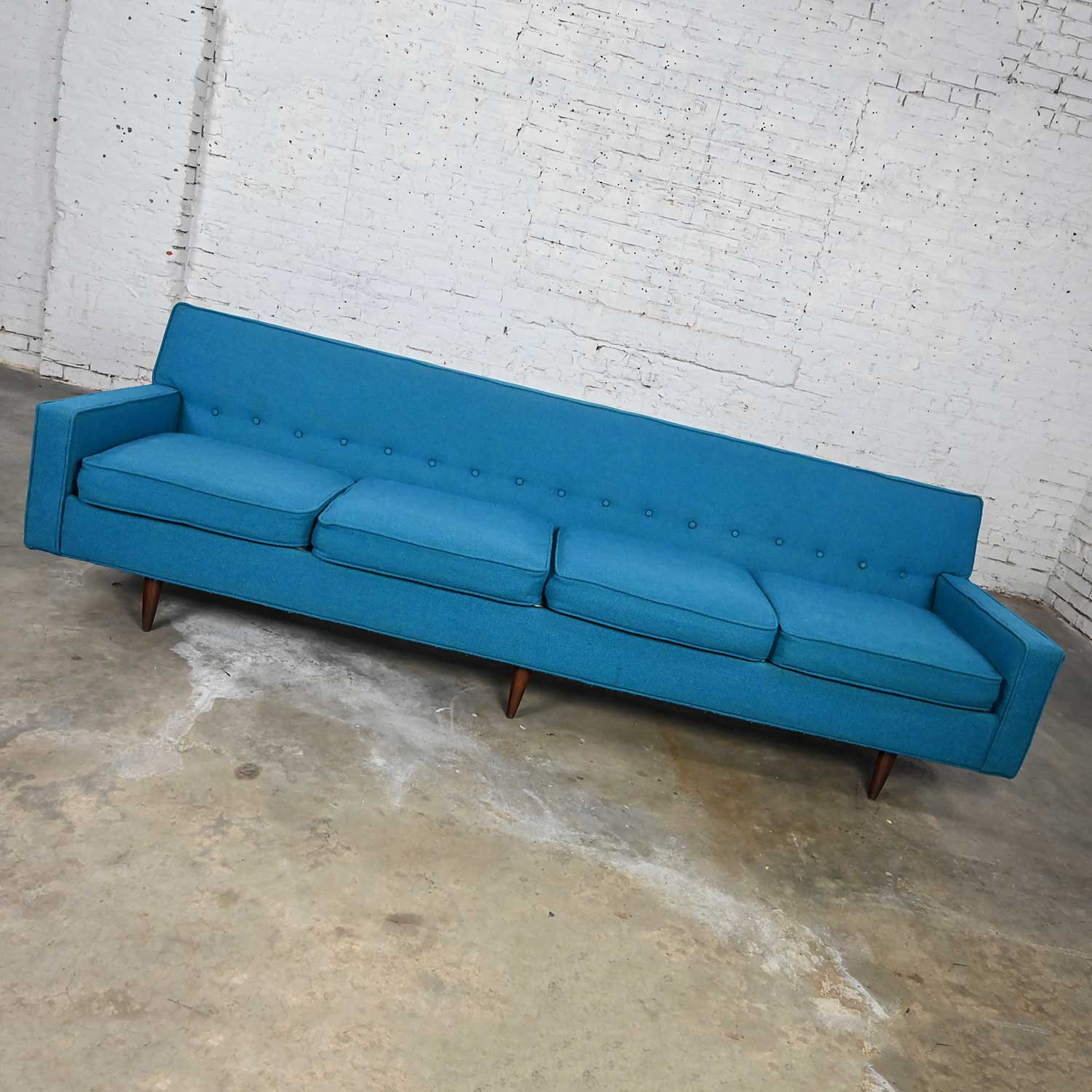 Gorgeous vintage mid-century modern turquoise Lawson style 4 cushion sofa attributed to Milo Baughman for James Inc. Comprised of four loose zippered seat cushions, six tapered walnut legs, and turquoise hopsacking fabric with back button detail.