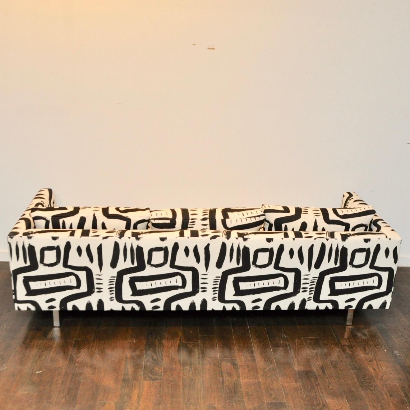 Tuxedo sofa in the manner of Harvey Probber. Newly reupholstered in custom fabric designed by New York designer Patrick Mele. This is not only a comfortable sofa, but a piece of art as well.