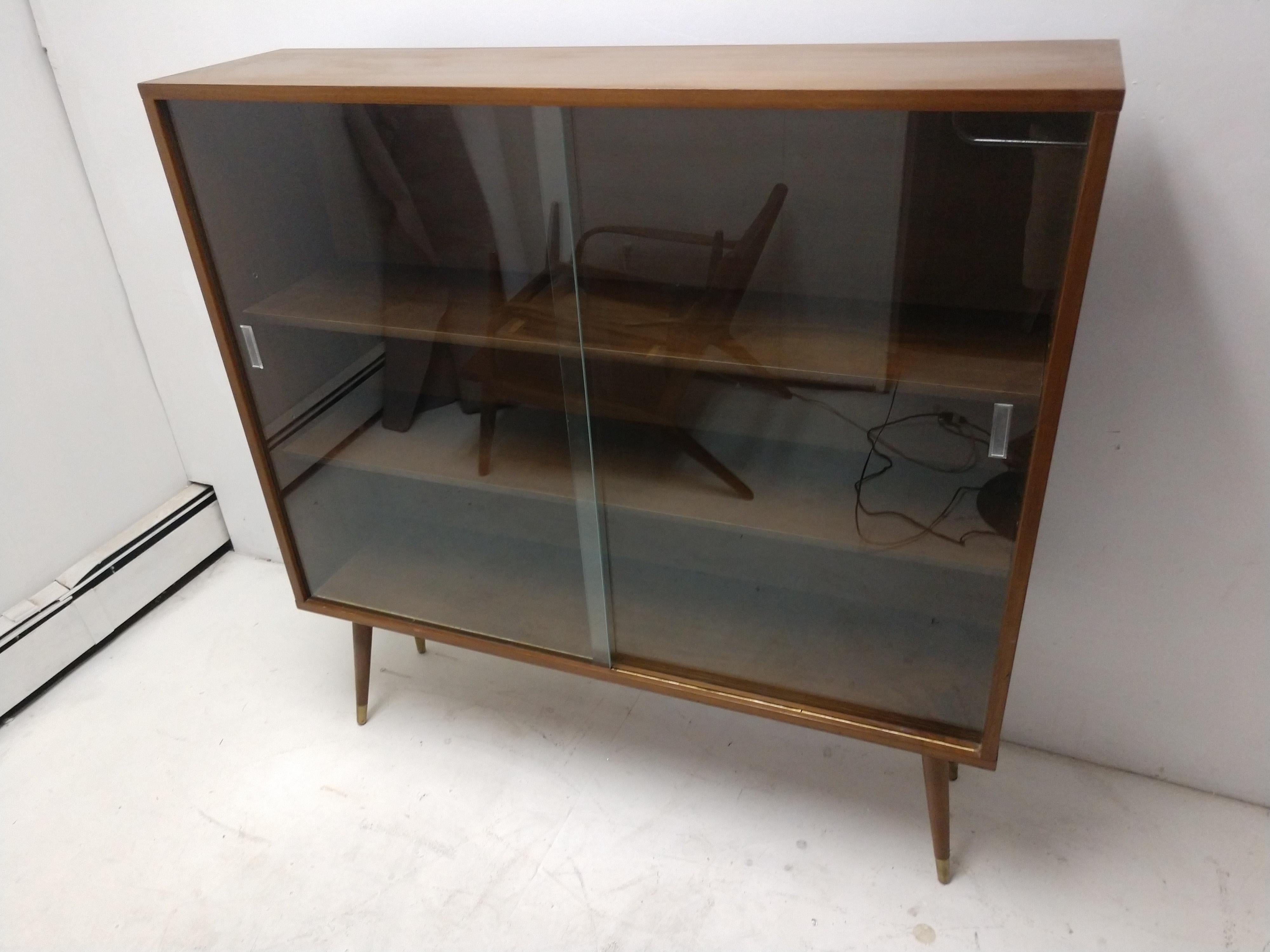 mid century bookcase with glass doors