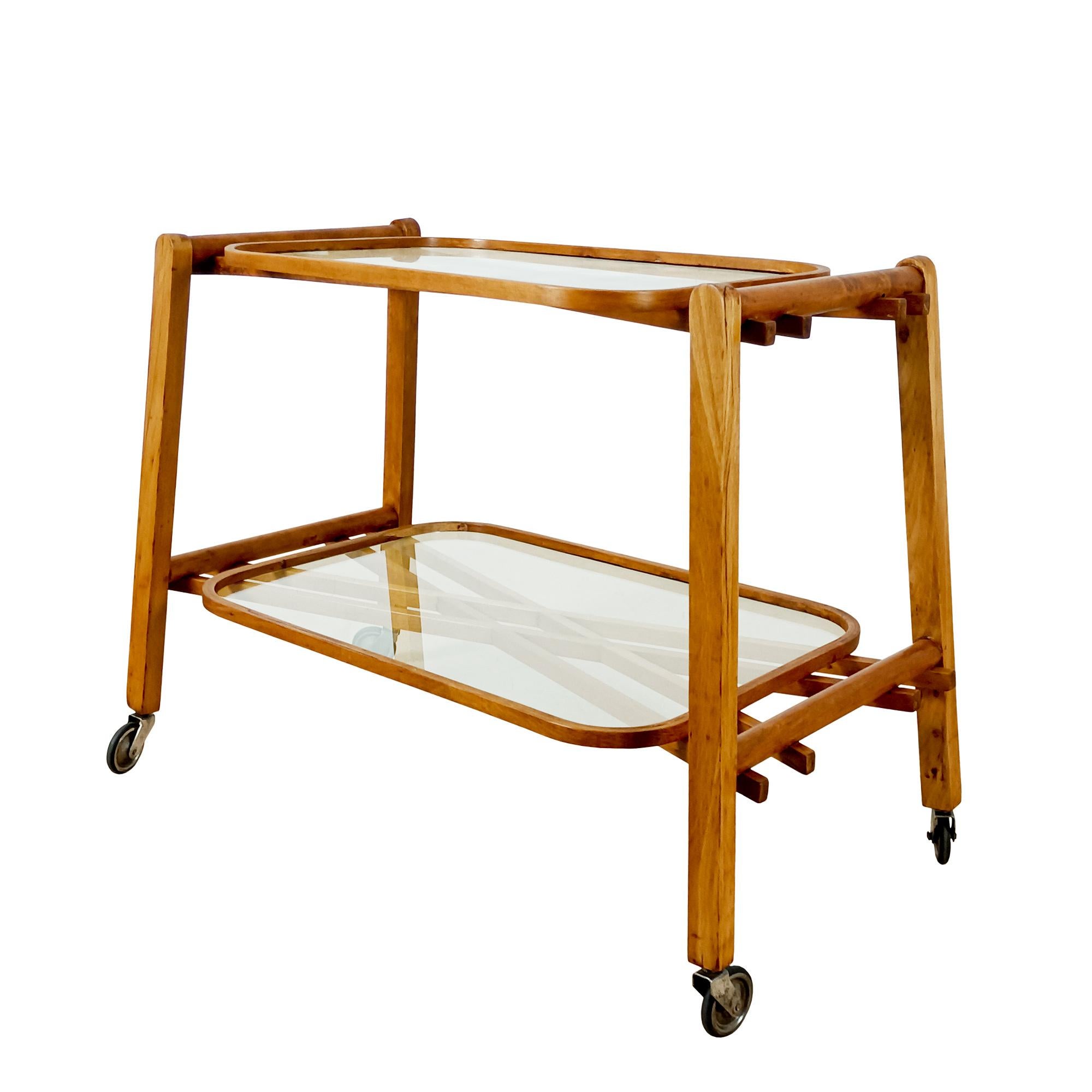 Two-level serving cart with solid oak structure and braces, glass tops, original wheels. Shellac finish.
Italy 1940.

 