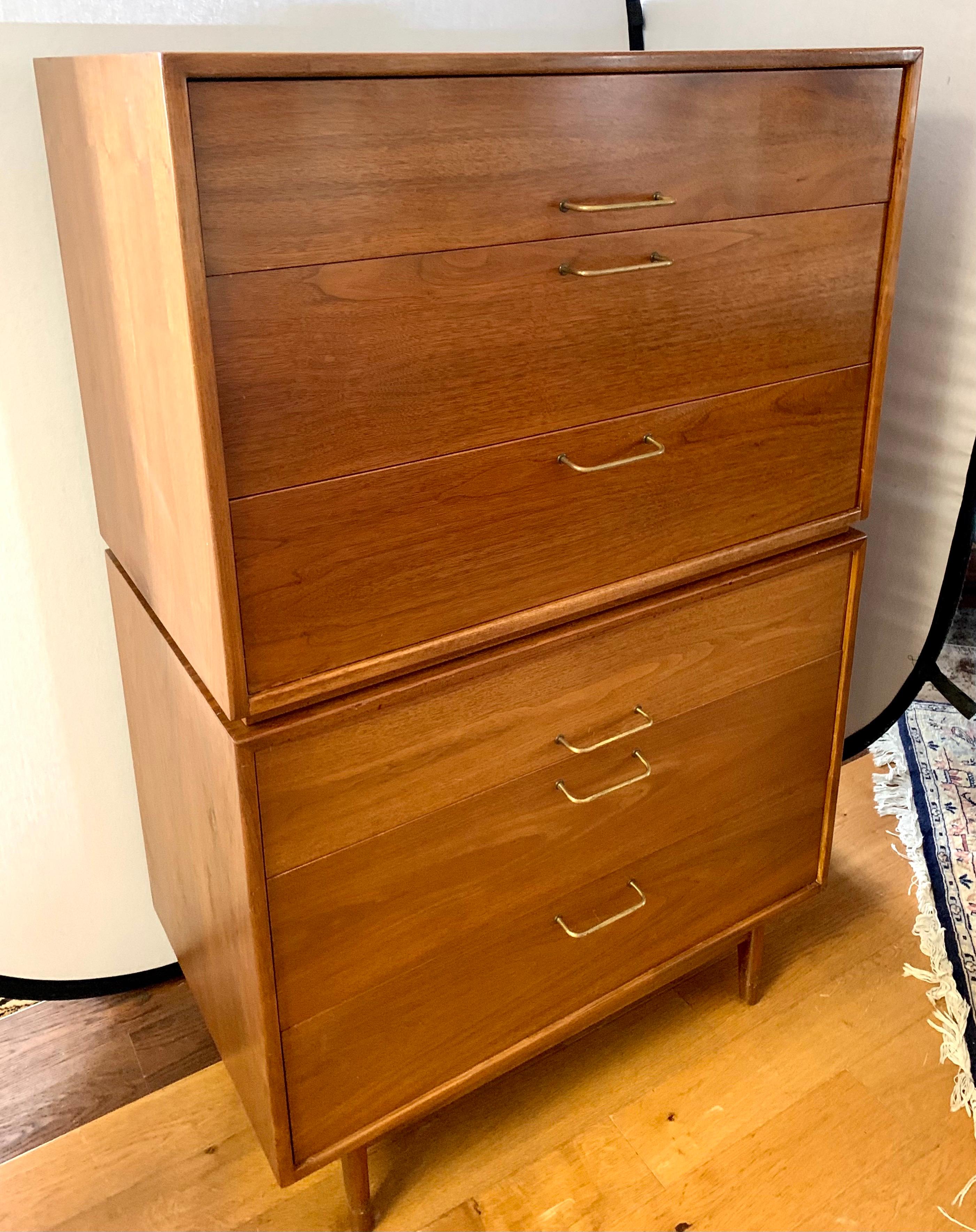 Mid century tall highboy is actually two pieces, the upper portion has three spacious drawers as does the bottom portion. It features beautiful wood grain and clean modern lines. Original brass hardware. Circa 1970s and in the same vein as George