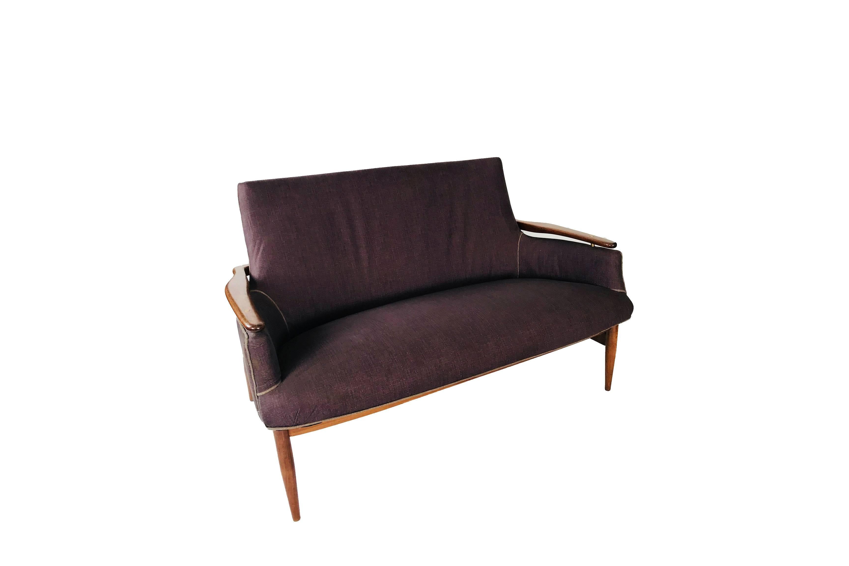 A sculptural settee, in the style of Finn Juhl model NV 53. Features an upholstered back and seat, with a wooden frame. Two-seat sofa, circa 1950, Copenhagen, Denmark.


     