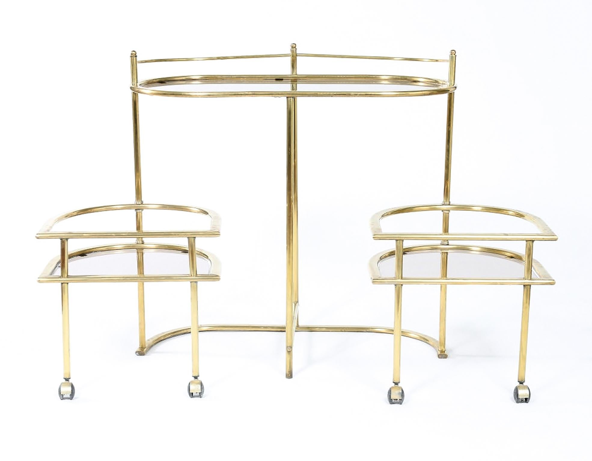 Mid-Century Modern two tiered brass/tinted glass bar cart with two swing out serving tables . The bar cart is in good vintage condition with appropriate wear consistent with age / use . It measures about 34.5 inches high X 35 inches wide X 18.5