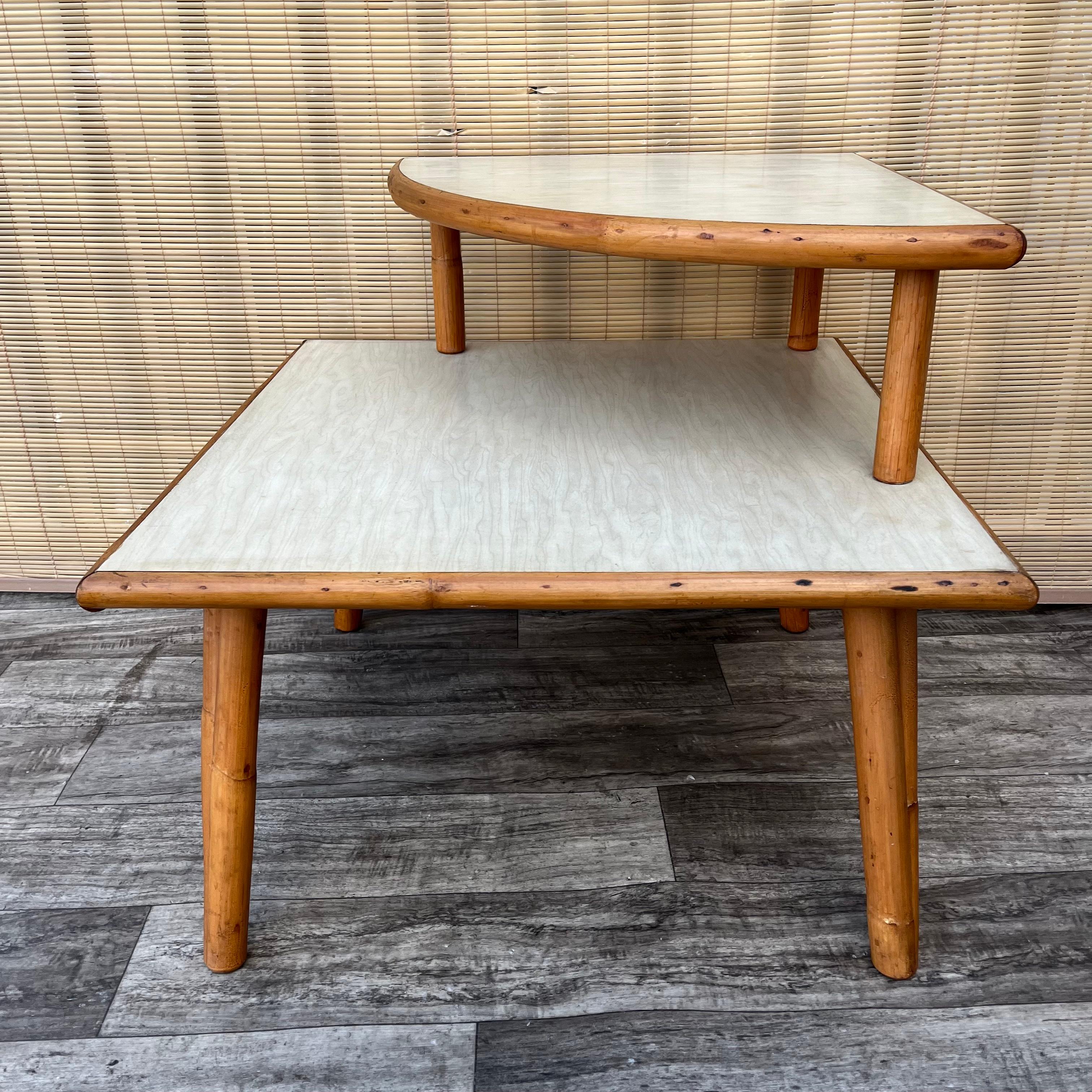 Mid-20th Century Mid Century Modern Two Tiered Rattan Corner Table. Circa 1950s For Sale
