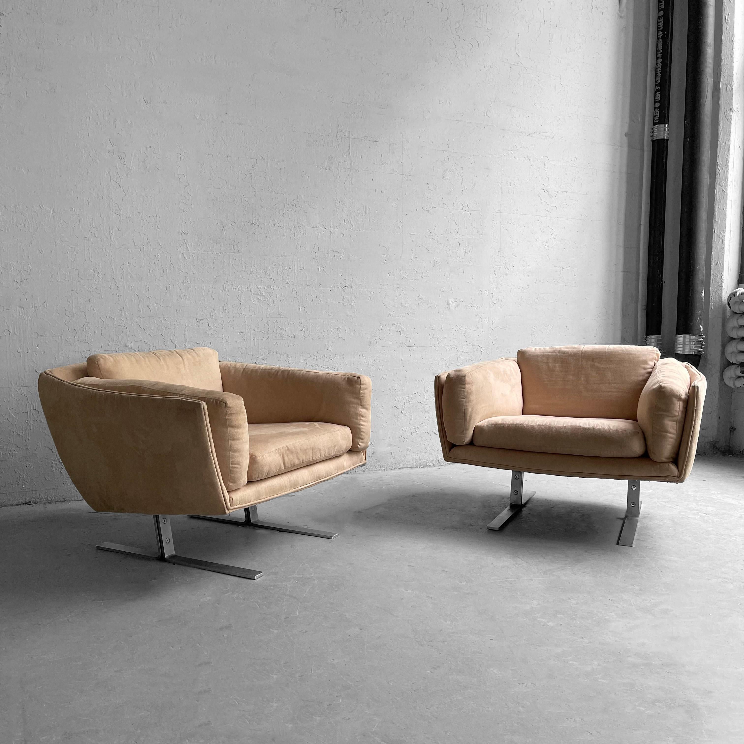 Pair of mid century modern, club, lounge chairs in the style of Milo Baughman feature flat bar chrome bases with fully upholstered bodies and cushions in cream ultra suede. The chairs present a sleek, low profile while also being very comfortable.