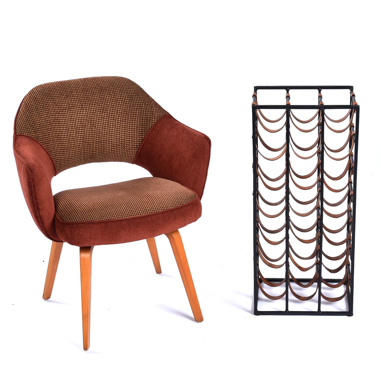 This listing is for the wine rack alone. The chair and other accessories are NOT included.

Iconic Mid-Century Modern leather strap and wrought iron wine rack by Arthur Umanoff. The vintage 1950s wine rack holds 21 wine bottles suspended on leather