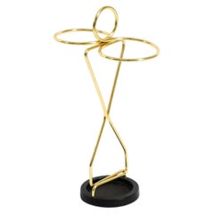 Mid-Century Modern umbrella stand featuring brass and a black cast-iron base