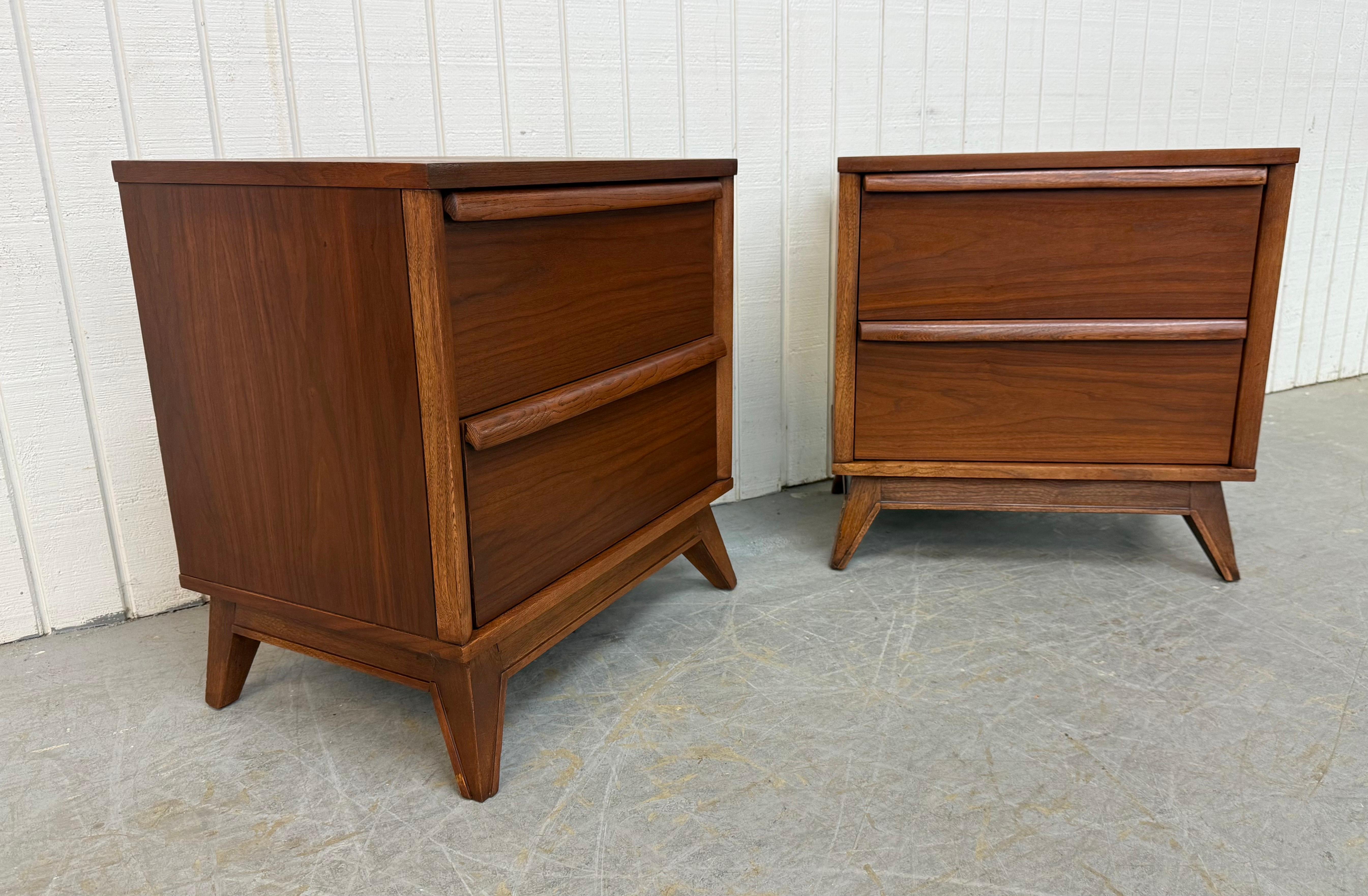 This listing is for a pair of -Century Modern Unagusta Walnut Nightstands. Featuring a straight line design, two drawers with wooden pulls, angular modern legs, and a beautiful walnut finish. This is an exceptional combination of quality and MCM