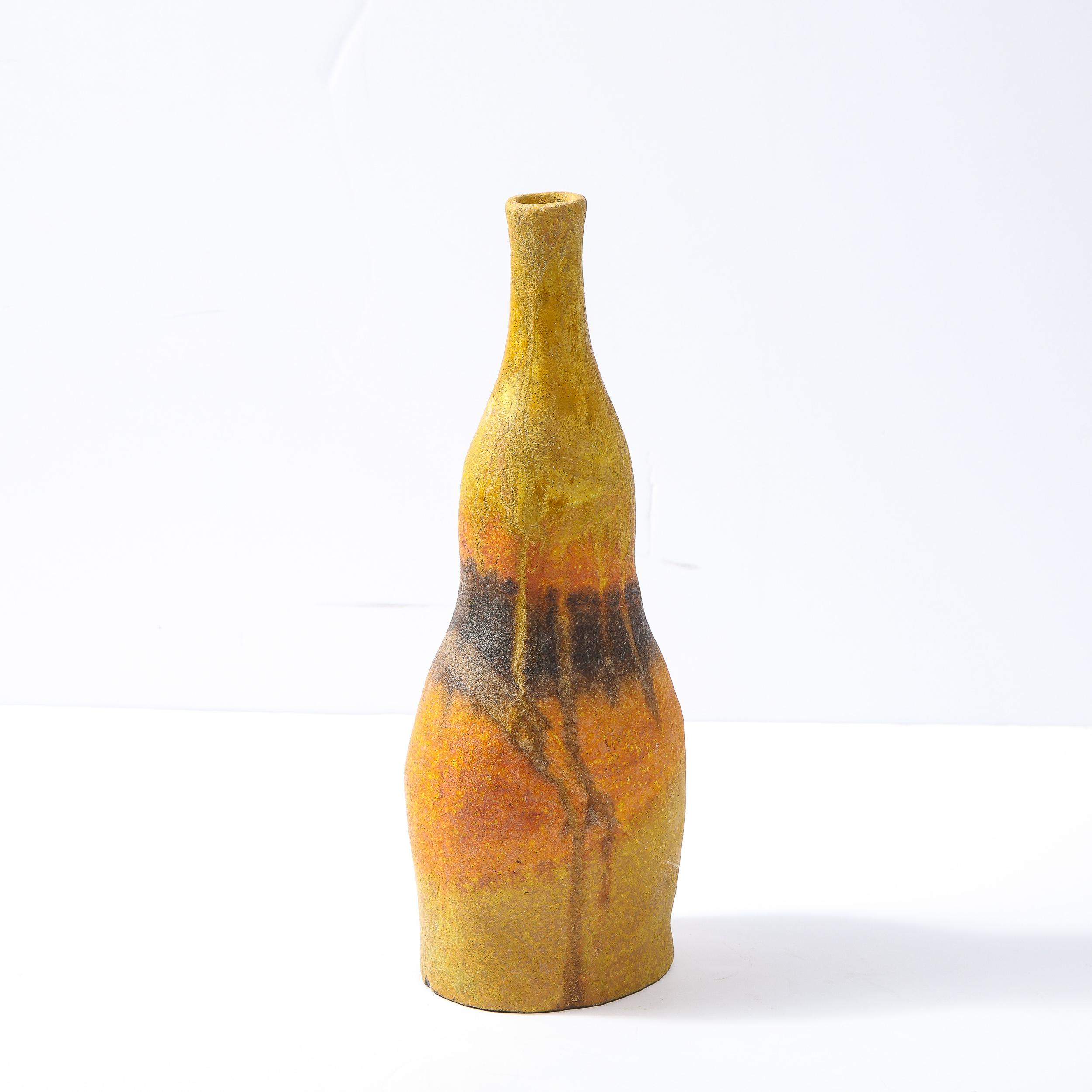 This stunning sculptural vase was realized in Italy, circa 1960 by the esteemed designer and visual artist Marcello Fantoni. It offers an undulating form- full of sinuous curves- in ceramic, hand embellished with expressionistic pigments in sherbet
