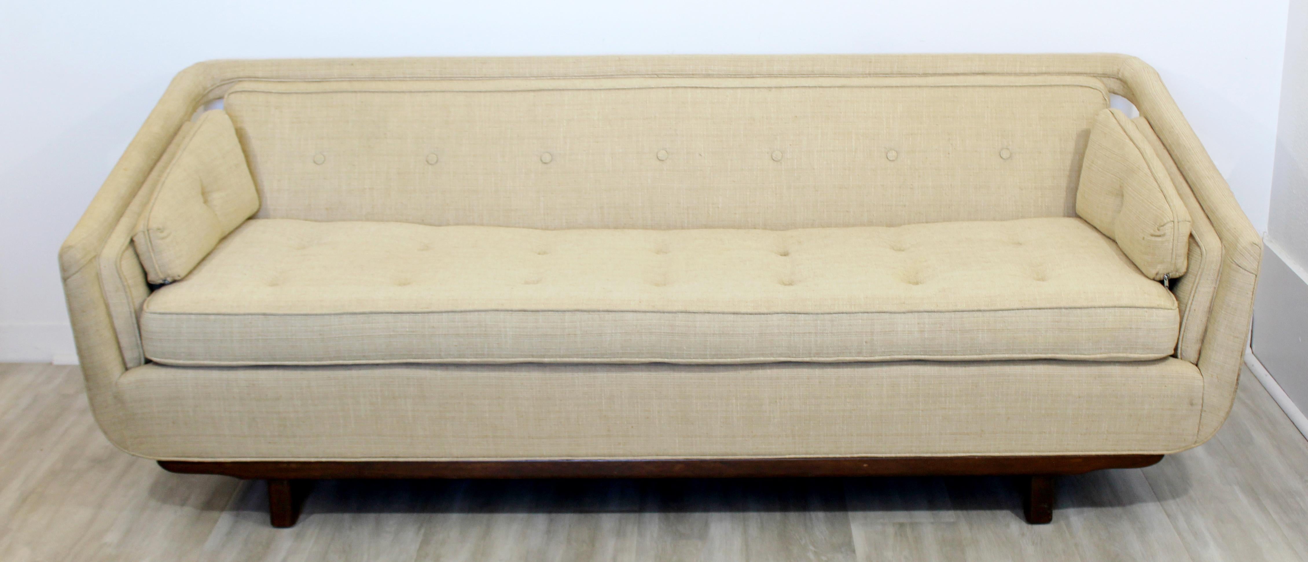 For your consideration is an elegant and sculptural sofa, in a raw silk blend, attributed to Dunbar or Laszlo, circa 1960s. In excellent vintage condition. The dimensions are 79.5