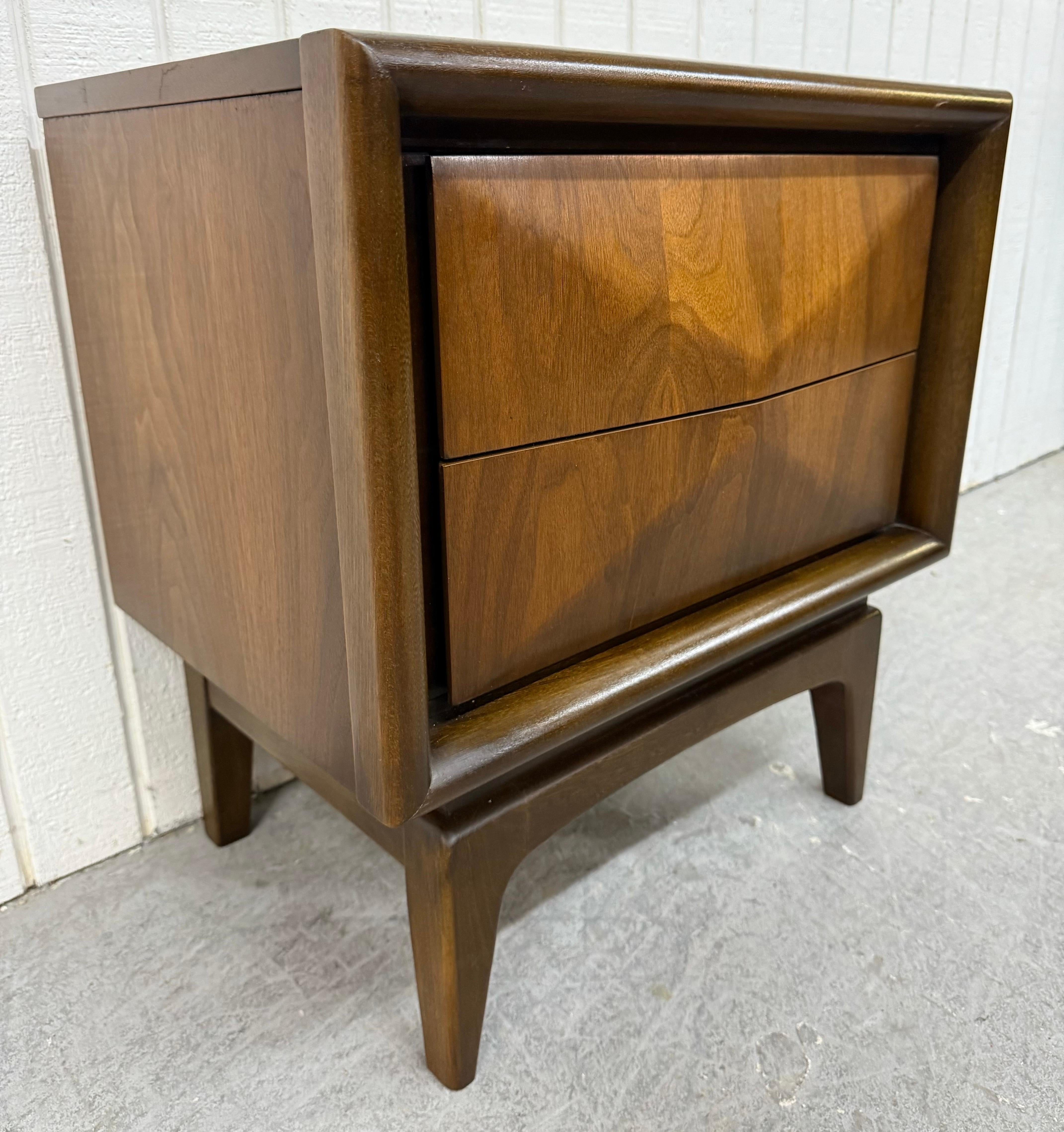 This listing is for a Mid-Century Modern United Diamond Walnut Nightstand. Featuring a straight line design, two diamond shaped drawers, modern legs, and a beautiful walnut finish. This is an exceptional combination of quality and design by United