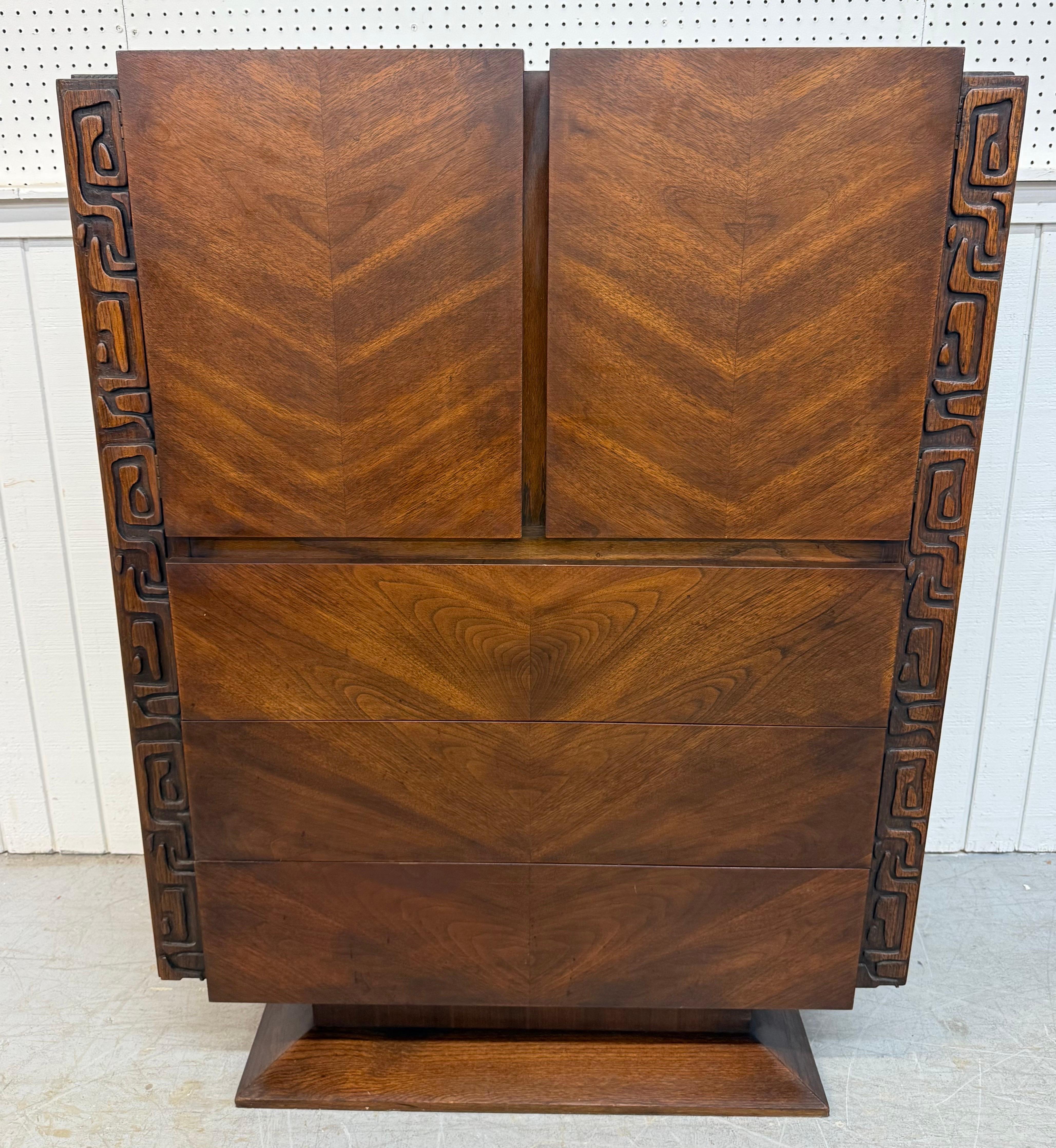 This listing is for a Mid-Century Modern United Tiki Walnut Bedroom Set. Featuring a six piece set that includes a high chest, 9-drawer dresser, pair of nightstands, and pair of mirrors. This rare set is an exceptional combination of quality and MCM