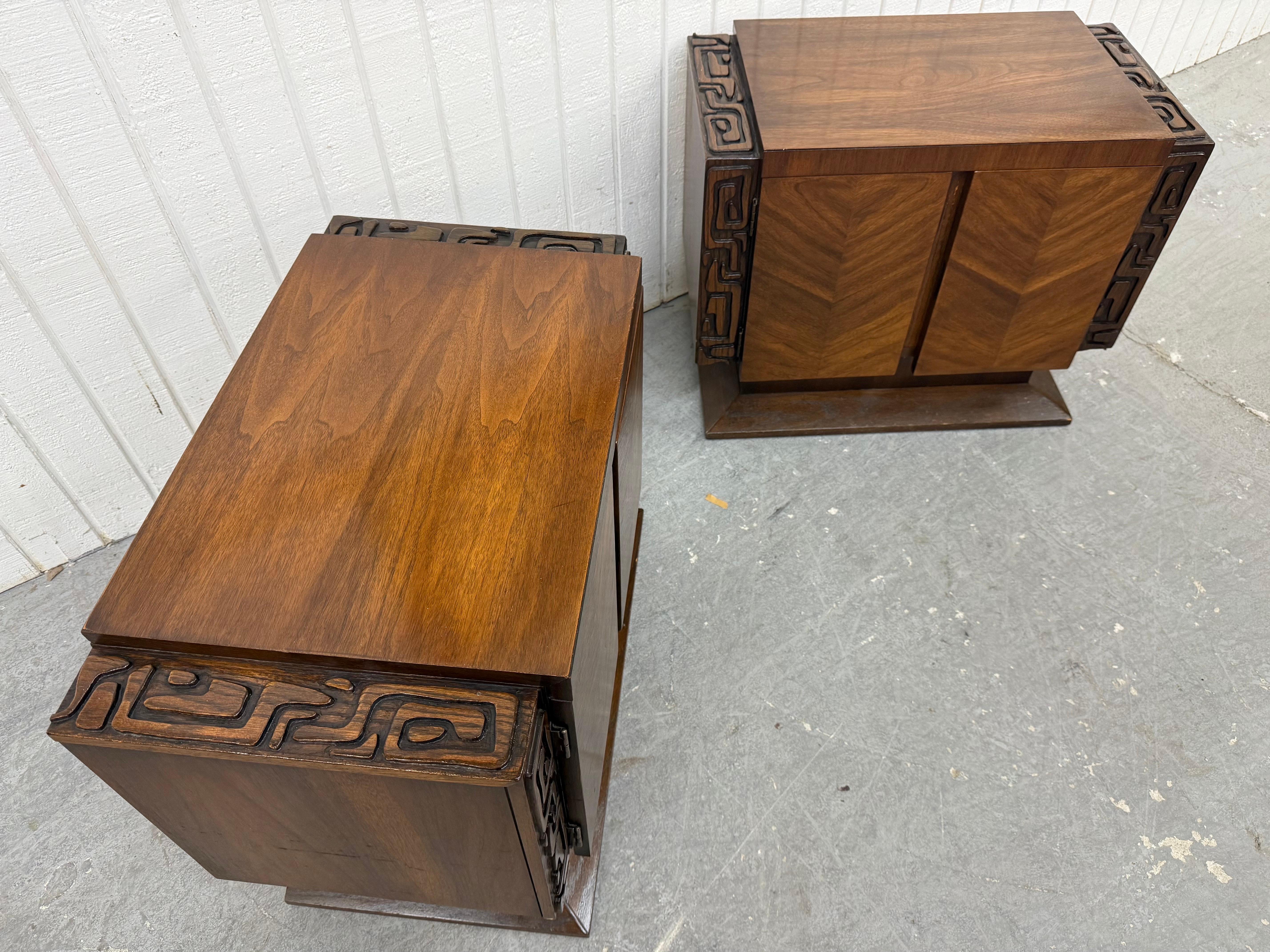 This listing is for a pair of Mid-Century Modern United Tiki Walnut Nightstands. Featuring a straight like brutalist design, two doors that open up to storage space, pedestal base, and a beautiful walnut finish. This is an exceptional combination of
