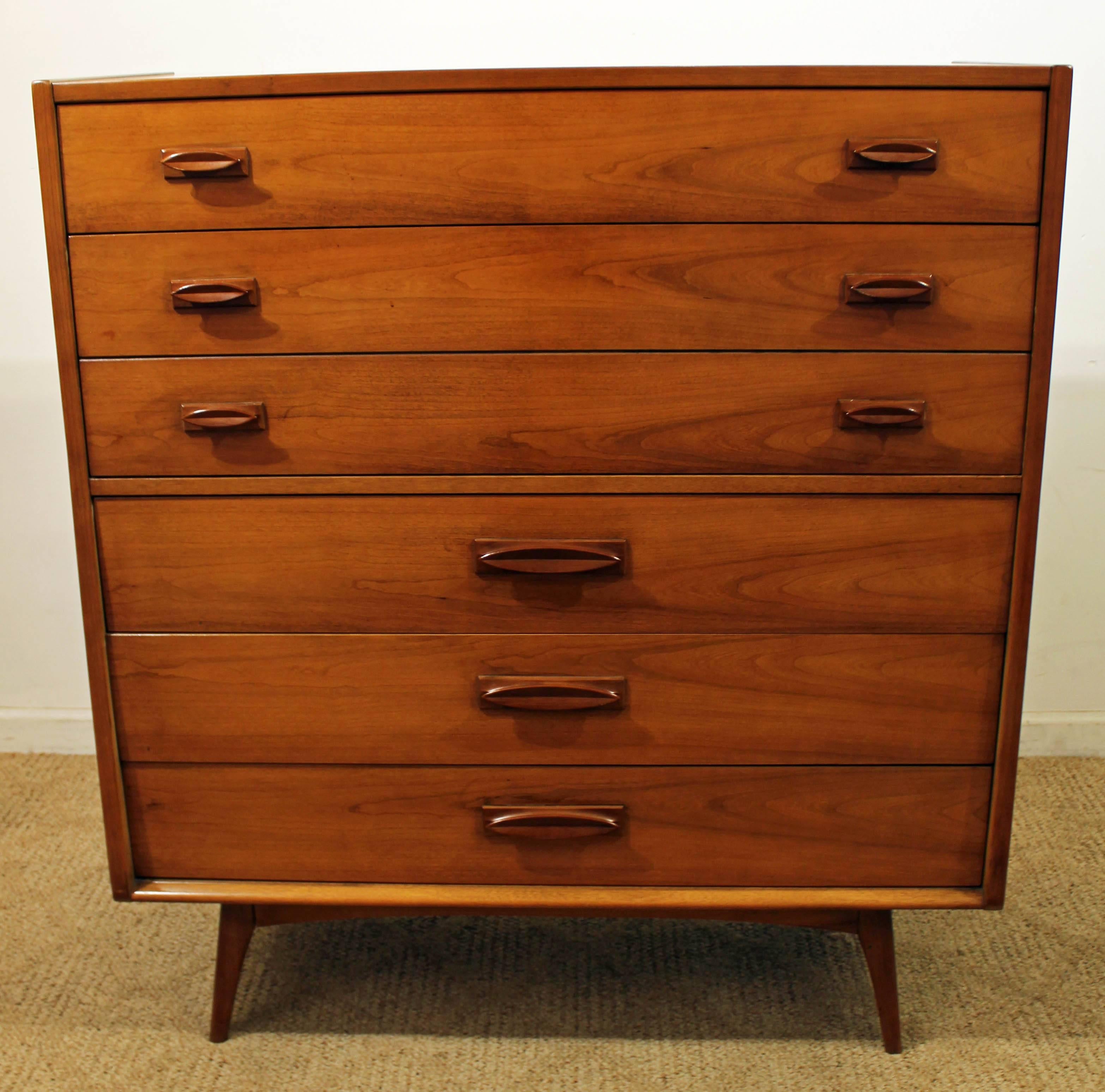 Offered is a Mid-Century Modern tall chest. We are unsure of the wood type. It features 5 dovetails drawers (including one double drawer). It is in excellent condition, shows minor signs of wear. It is signed by United. Check out our other listings
