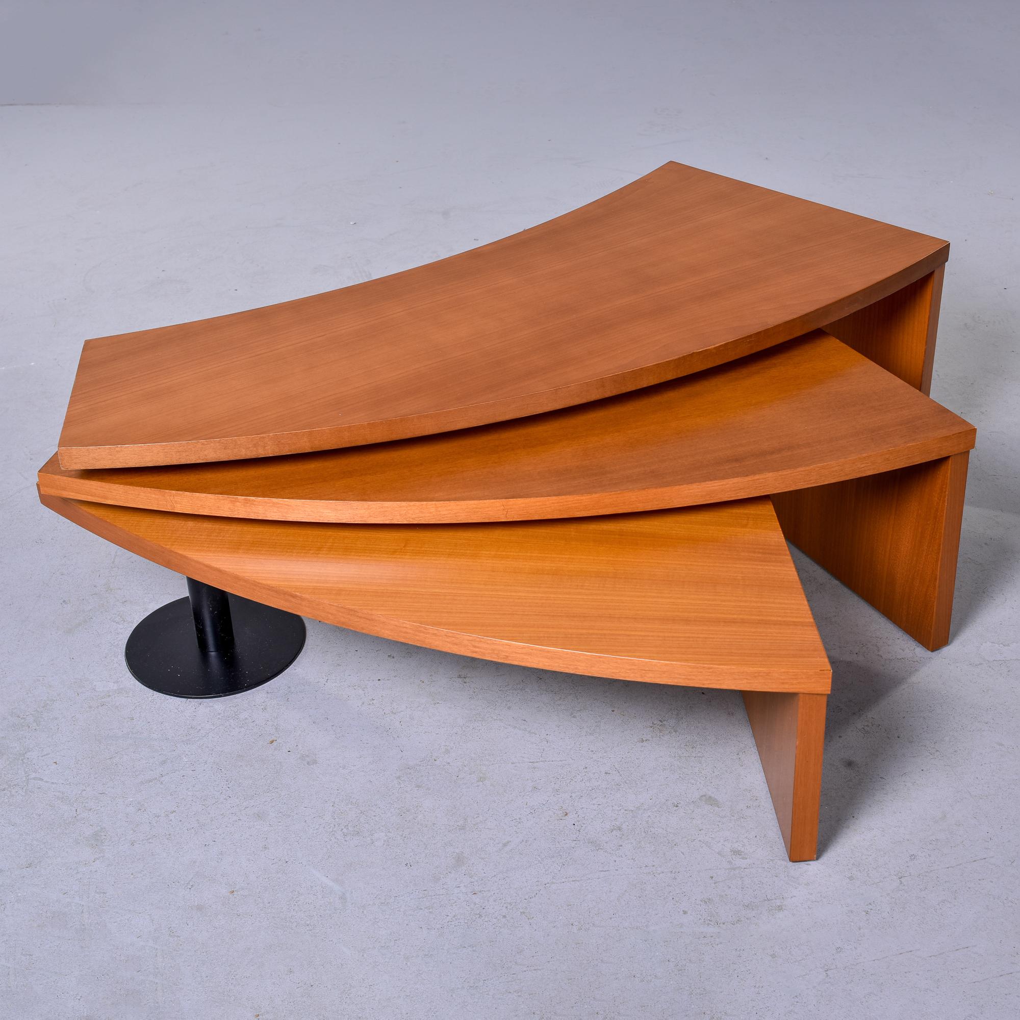 Found in Italy, this swiveling three level coffee table dates from the 1980s. There is a single black iron leg and three nesting teak table tops that can be fanned out to varying widths. Versatile table that works well in a large seating area.