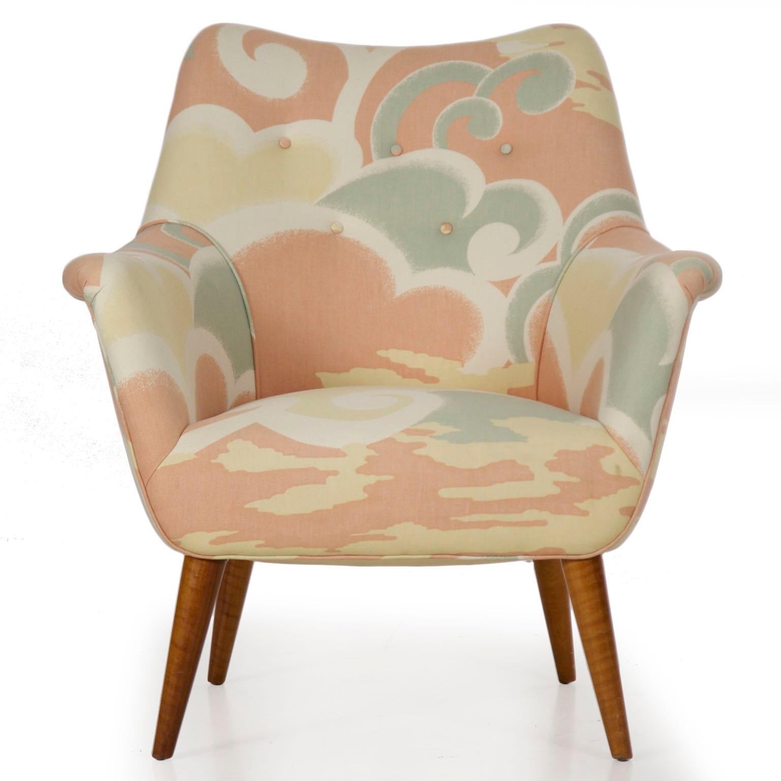 A very nice circa 1960s armchair in a vibrant period printed fabric, the chair has wonderful form and quality about it. It rests over tapered outward splayed maple legs and is incredibly comfortable. It is an excellent strikepoint for the modern