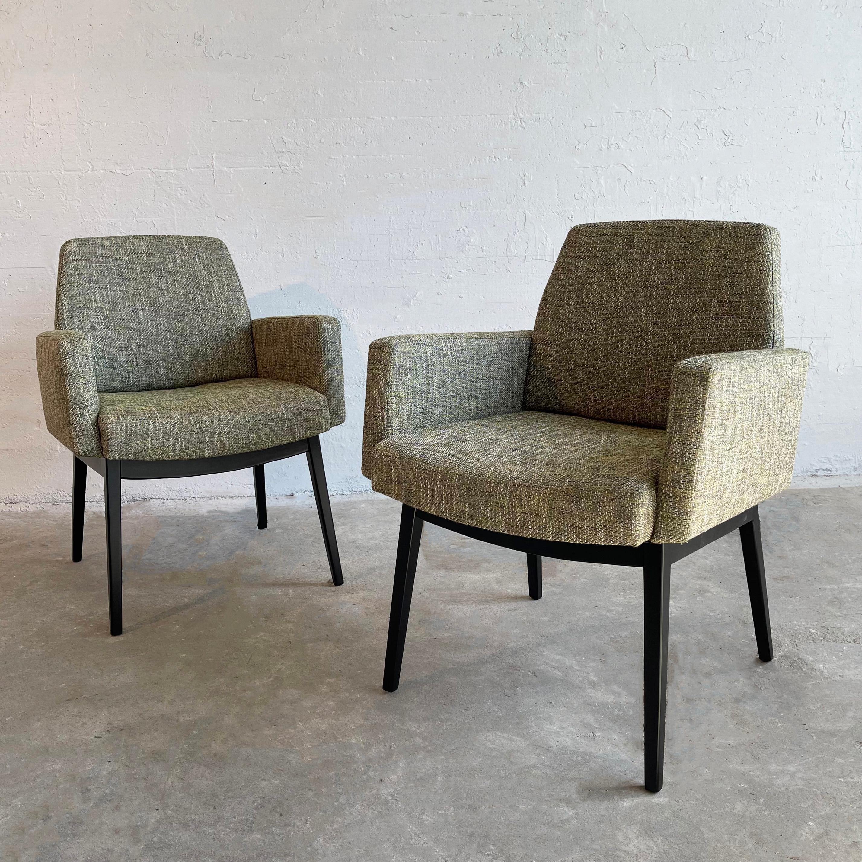 This pair of mid-century modern armchairs by Jens Risom feature lacquered walnut legs with fully upholstered bodies in moss green tweed that is in keeping with Scandinavian color trends of the period. The chairs offer the comfort of an armchair with