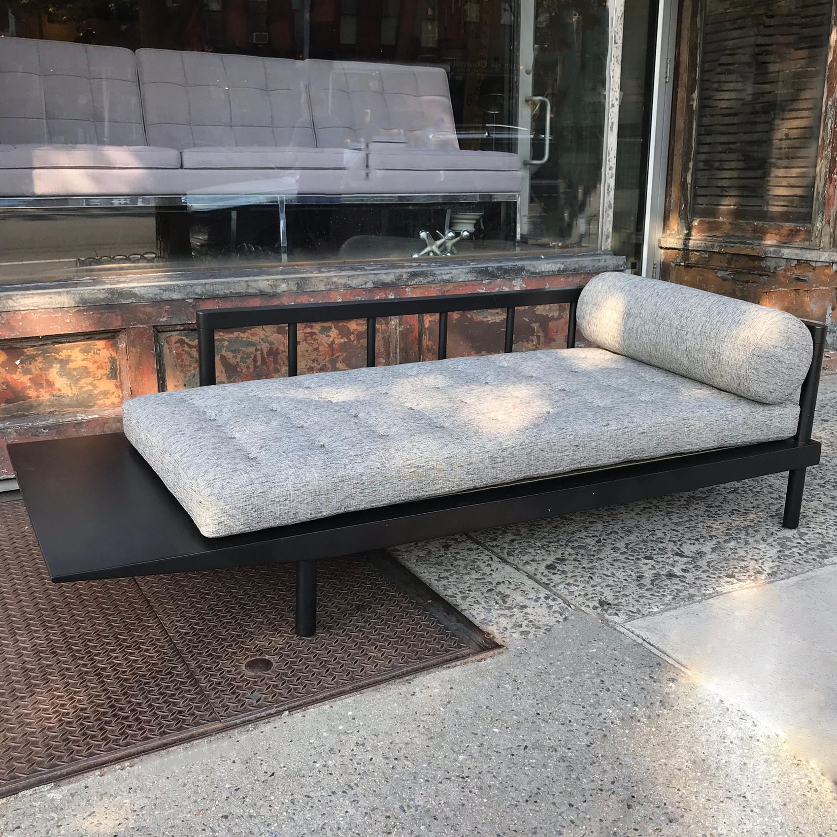 Low profile, mid century modern, daybed sofa attributed to George Nelson for Herman Miller features a cantilever side surface with rail back and side finished in black satin lacquer is newly upholstered in a salt and pepper cotton tweed with custom