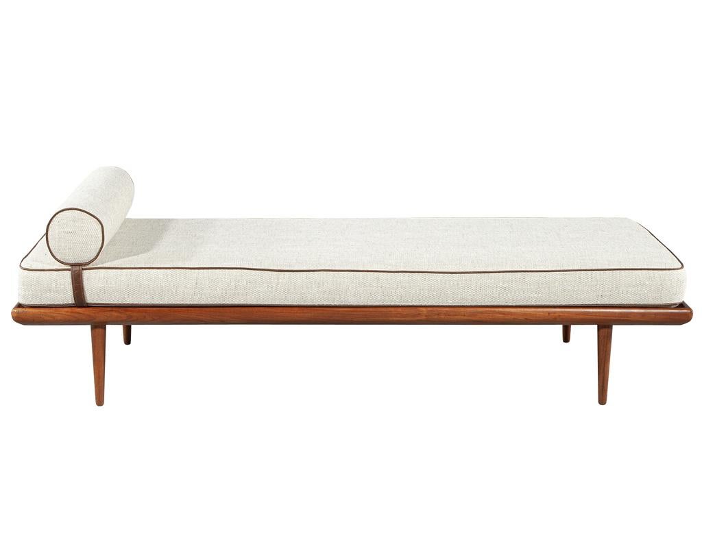 This beautiful vintage mid-century modern daybed, made in Denmark circa 1970's, is a timeless piece of craftsmanship and design. The frame is made from teak wood, giving it a warm and classic feel. The large seat cushion is upholstered in a textured