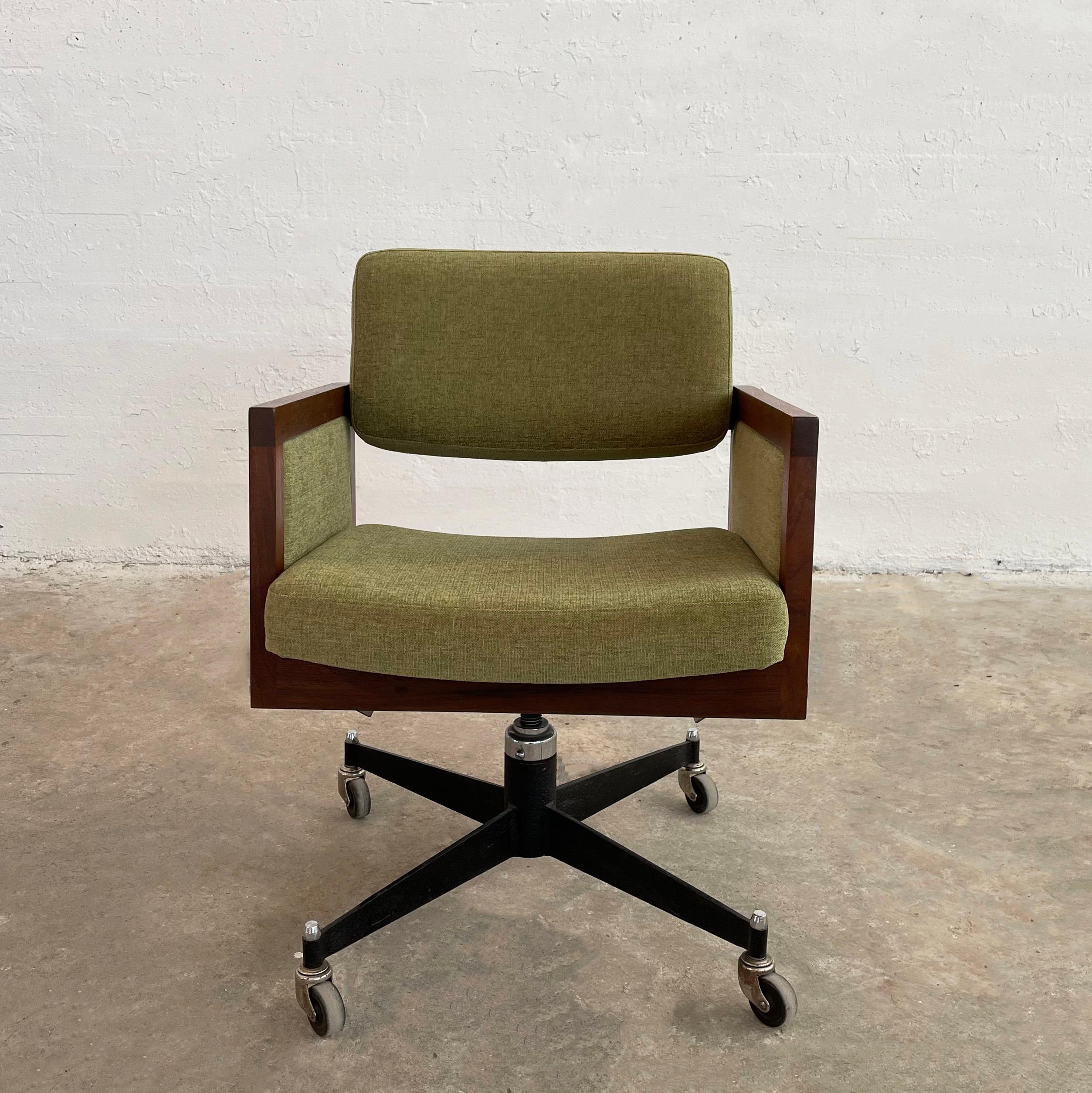 Mid-century modern, rolling, executive office armchair by Robert John is newly upholstered in olive green chenille trimmed in a walnut frame on a metal base.  The arm height measures 24.5 inches and footprint of base is 27 inches wide.