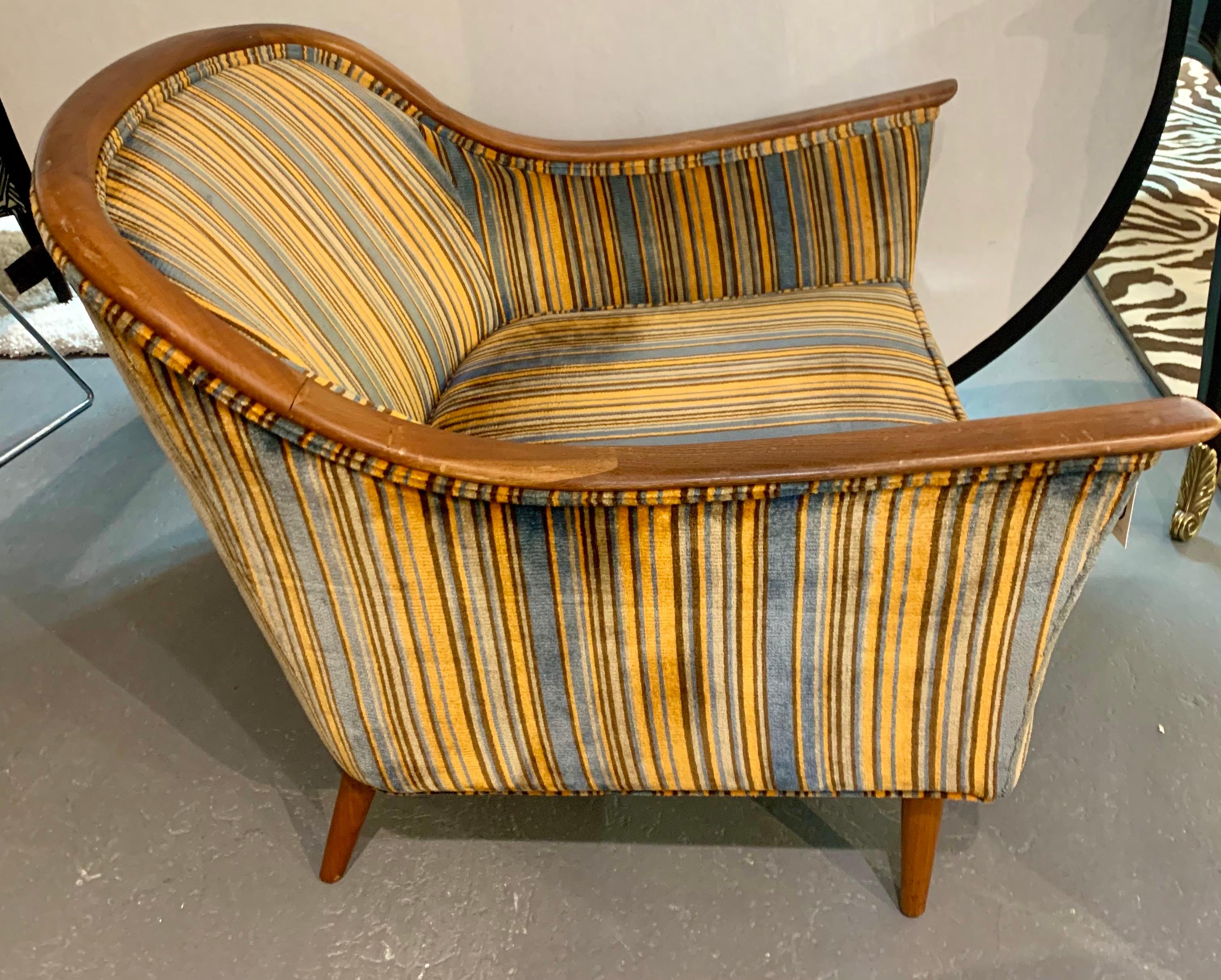 Iconic Mid-Century Modern lounge chair with original Jack Lenor Larsen fabric which feels like velvet. Bold stripes and color scheme. Wood appears to be walnut or fruitwood. Will make any room look elegant. Own the best.