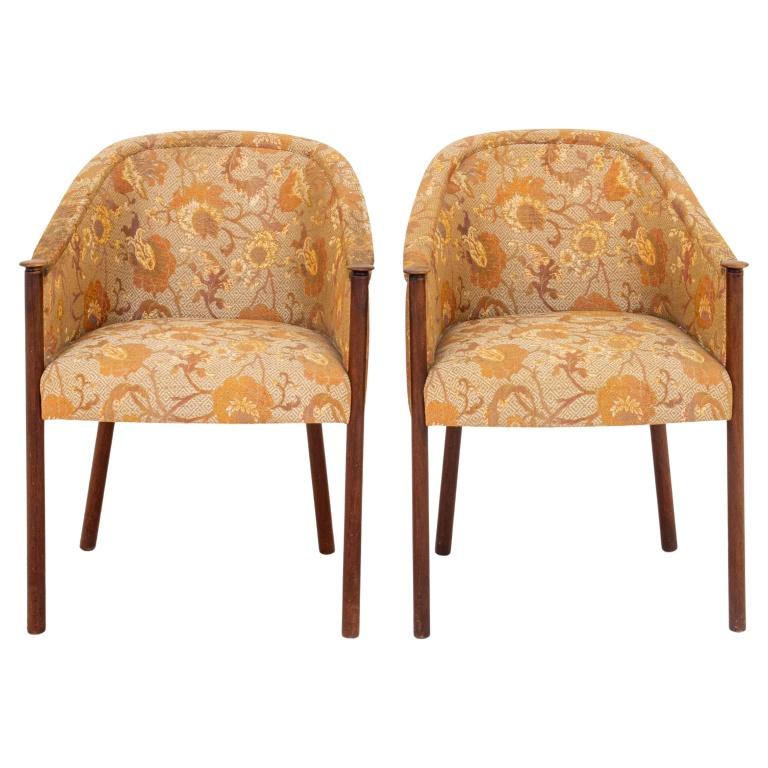 Mid-century Modern upholstered walnut armchairs, 1960s, with columnar uprights supporting a bergere back and shaped seats on tapering columnar legs, now upholstered in a yellow brocade.

Dealer: S138XX