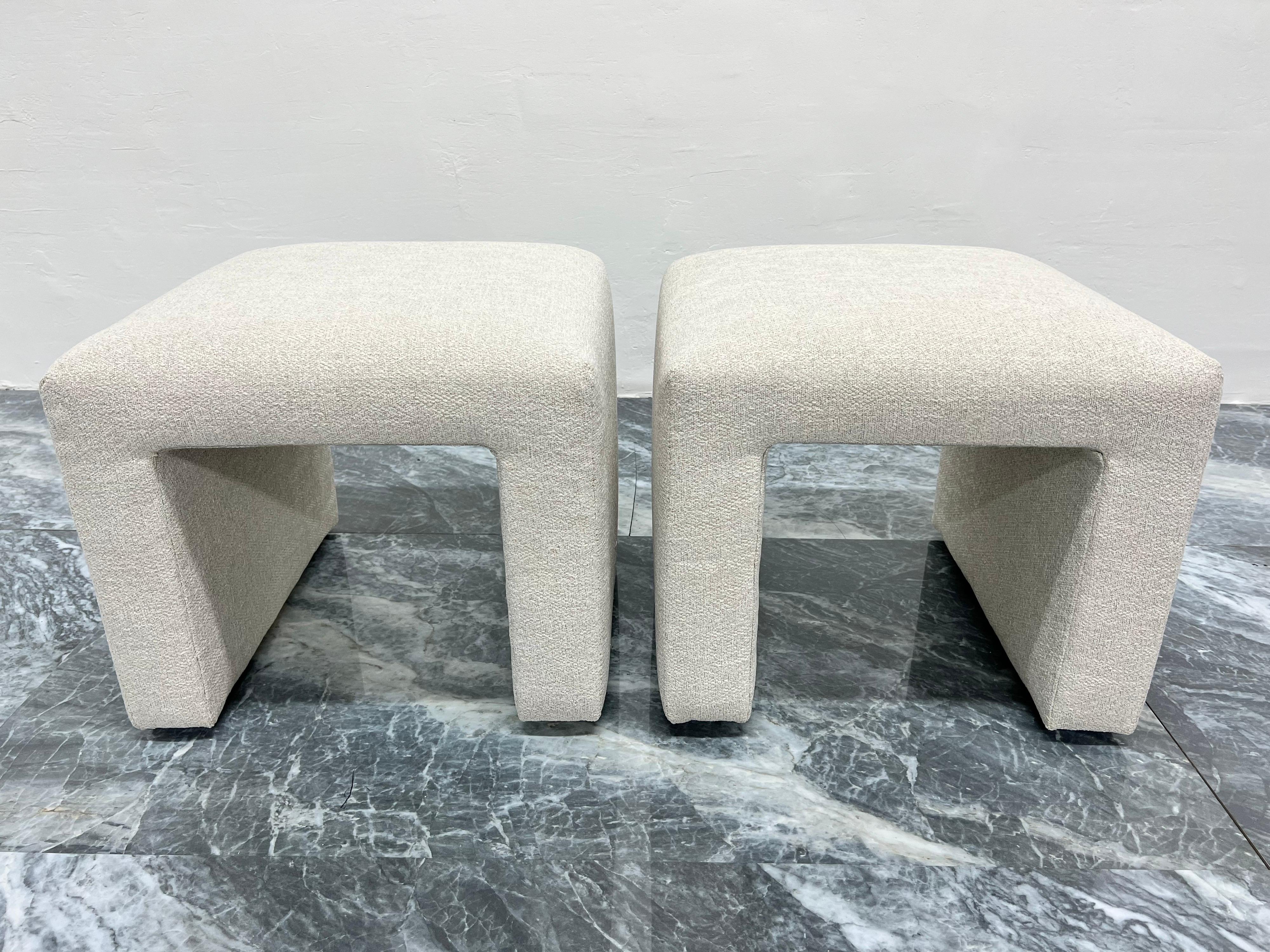 Pair of newly upholstered waterfall stools with natural linen and poly blend high end fabric. Stools are original from the 1970s and the off white fabric has a bit of sheen.