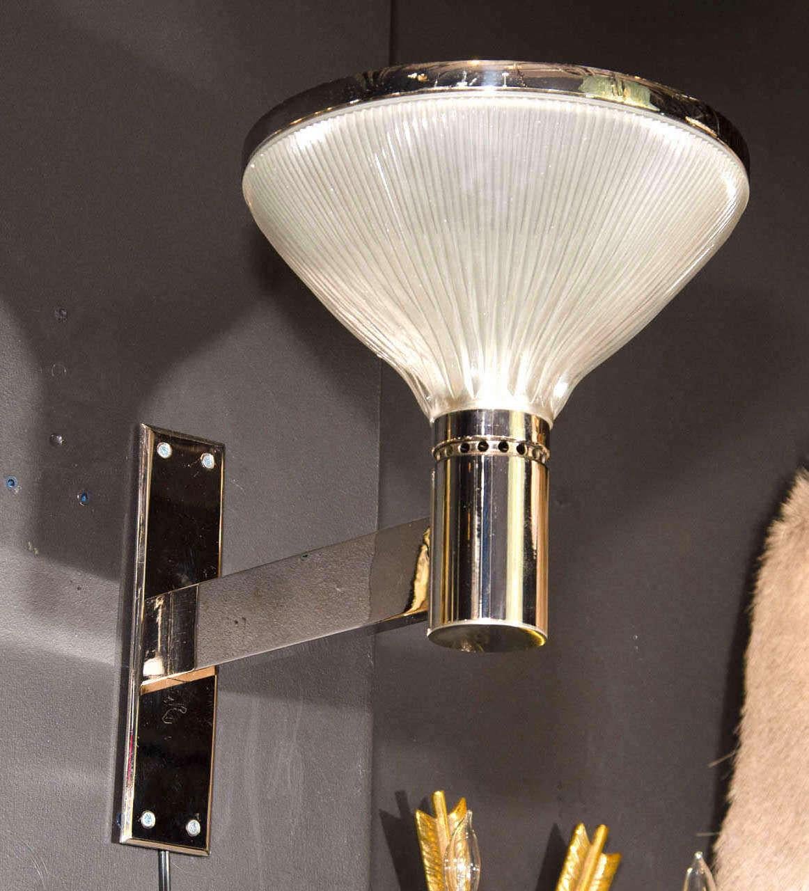 Mid-Century Modern torchiere uplight sconces with Art Deco and Machine Age inspired design. They feature bold polished chrome frames with extended arm design and fluted opaline glass domes with chrome banded tops. Sconces have a prominent design and