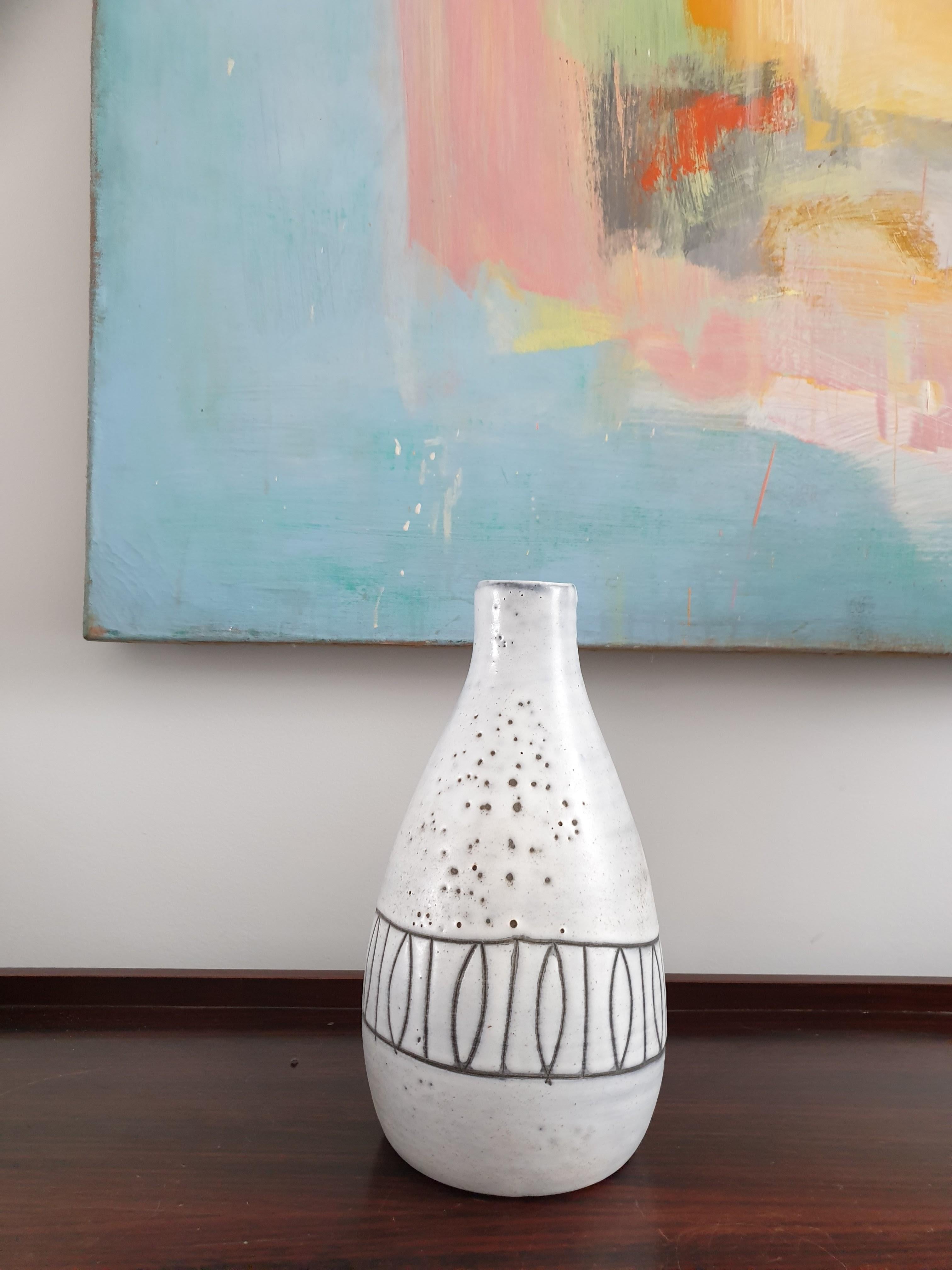 Ceramic stoneware vase by Atelier Dieulfit, France, signed to base. The simple abstract decoration of the vase would fit in well with a contemporary interior as would the cool grey detail. The vase has a hand made, artisan feel to it which gives it