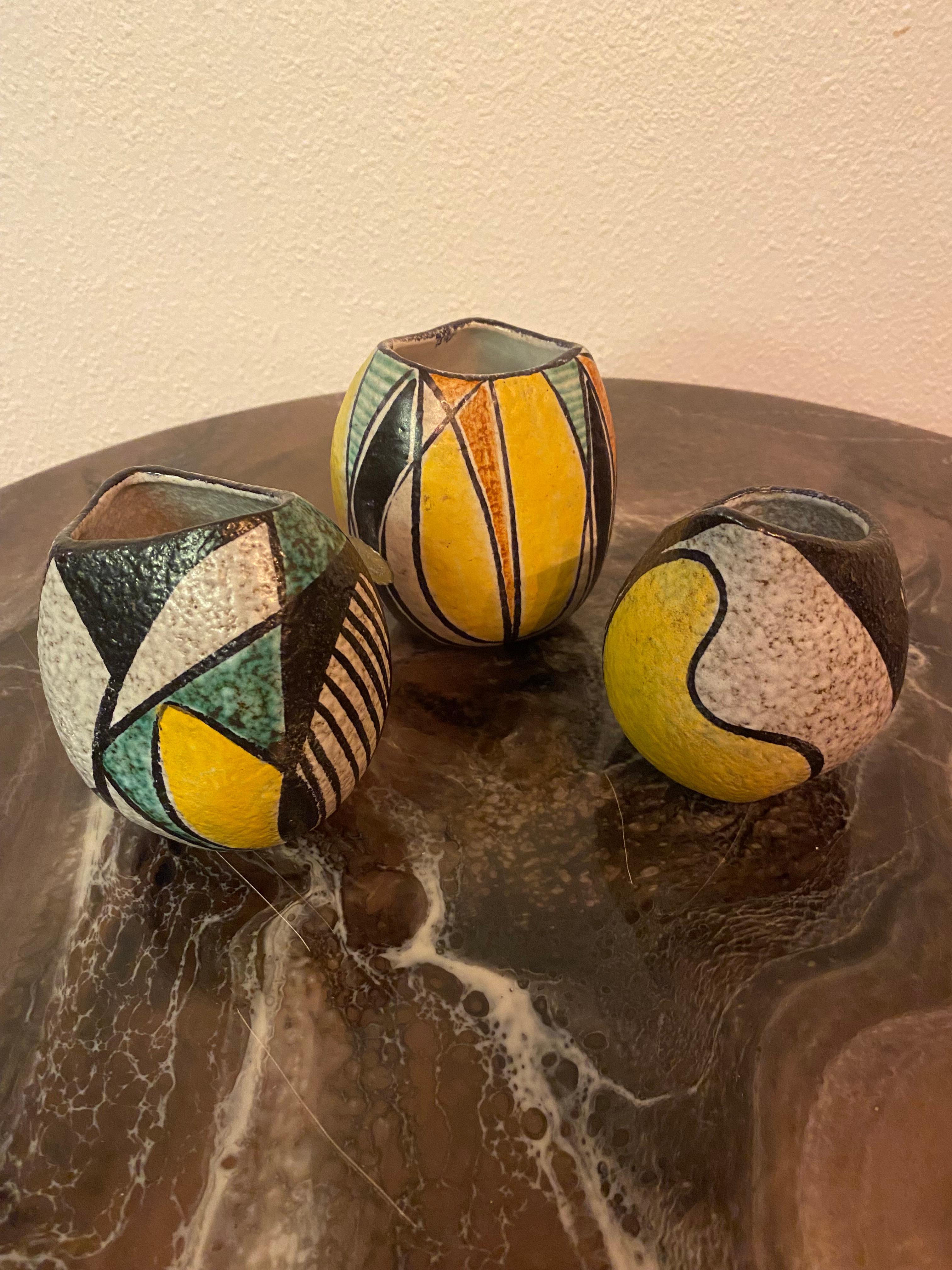 Just beautiful stylish tiny vases in matte glazing with geometric patterns in yellow, green, brown and black. Typical from the fifties/sixties

