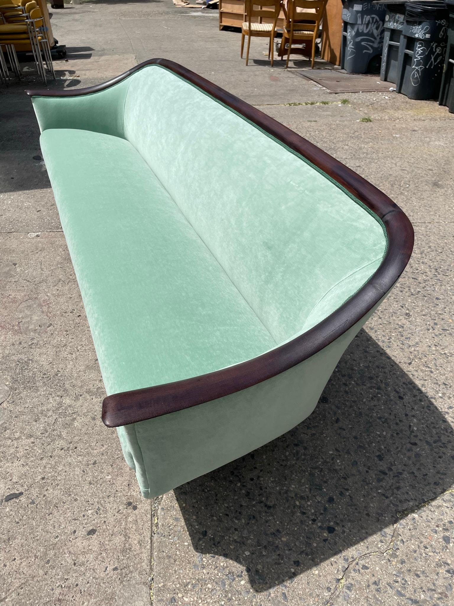    Completely reupholstered sofa
In an amazing green velvet. This sofa has all new cushioning and the solid wood frame has been sanded and sealed. 
   This fabulous piece is very comfortable and makes a great statement piece in any home. 
   If you