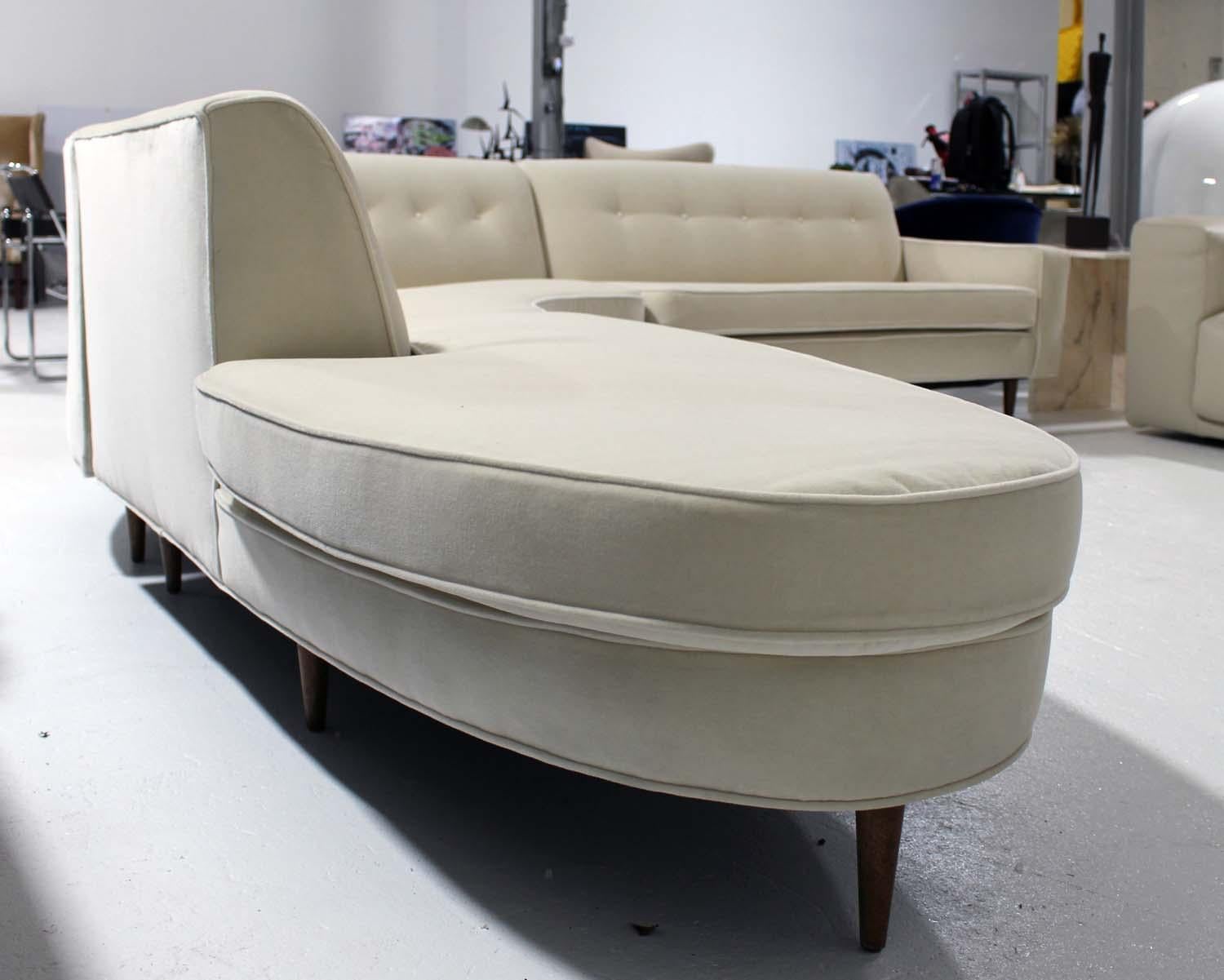 Amazing statement piece for any living room, or seating area. This 3-piece cream velvet sectional has iconic lines, beautiful new velvet upholstery, walnut legs, and incredible styling.