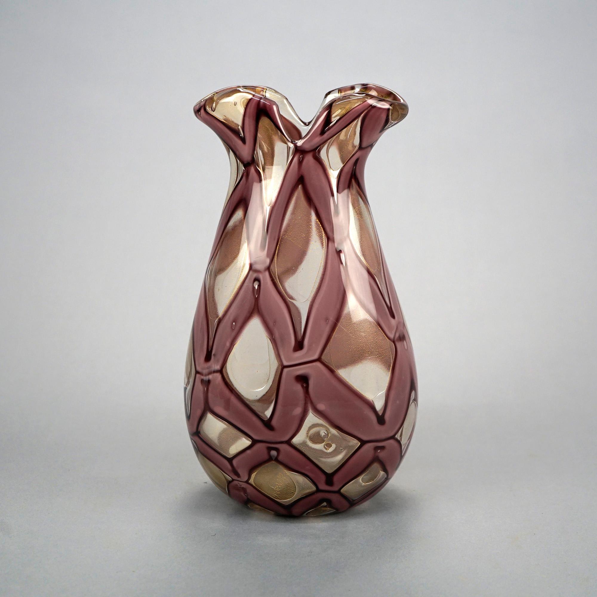 A Mid-Century Modern vase in the manner of Venetian Murano offers mouth blown stylized ribbon art glass construction with ruffled rim and lattice design, 20th C

Measures- 10.5'' H x 5.75'' W x 4.25'' D.