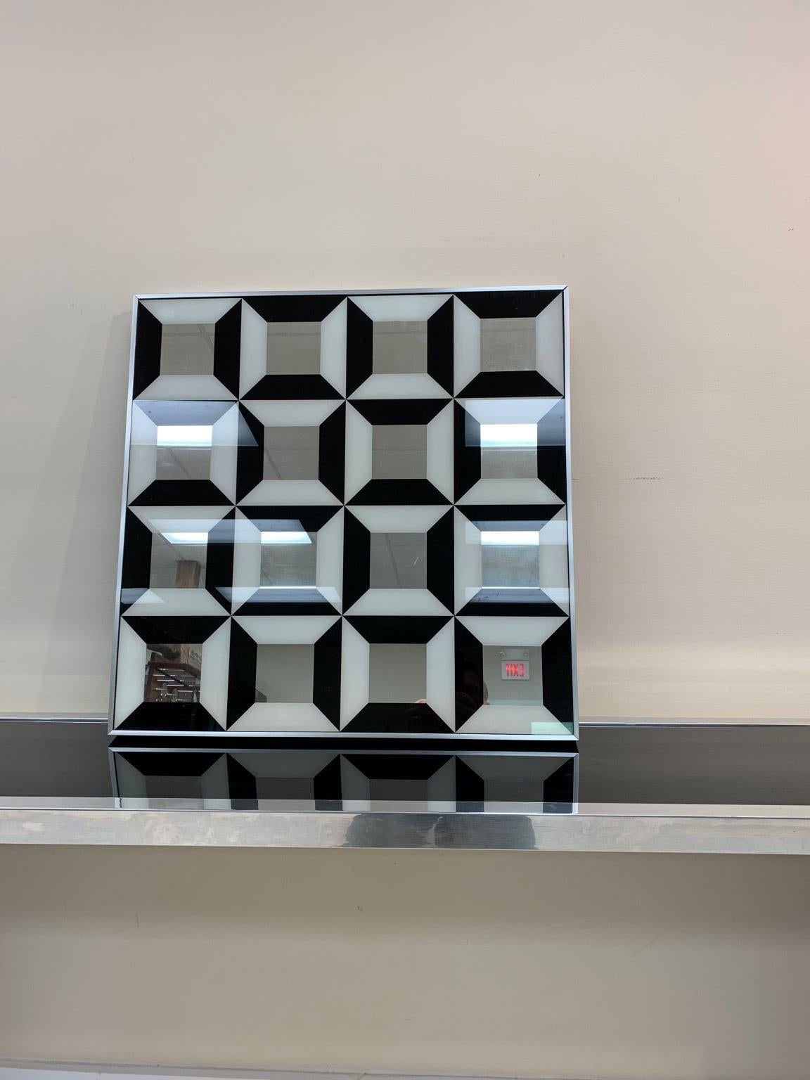 A fabulous, optical illusion art mirror, with a diamond design, by Turner Decorative Arts, in the style of Verner Panton, circa 1970s. In good condition. The dimensions are 24.25