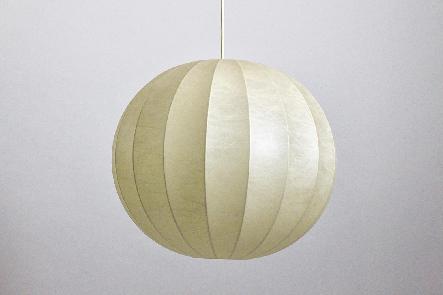 A Mid-Century Modern vintage iconic pendant or chandelier, which was designed by Achille & Pier Giacomo Castiglione, 1960s, Italy.
The cocoon ball pendant shows the original cover.
One E 27 socket
The condition is very good.
Approximate